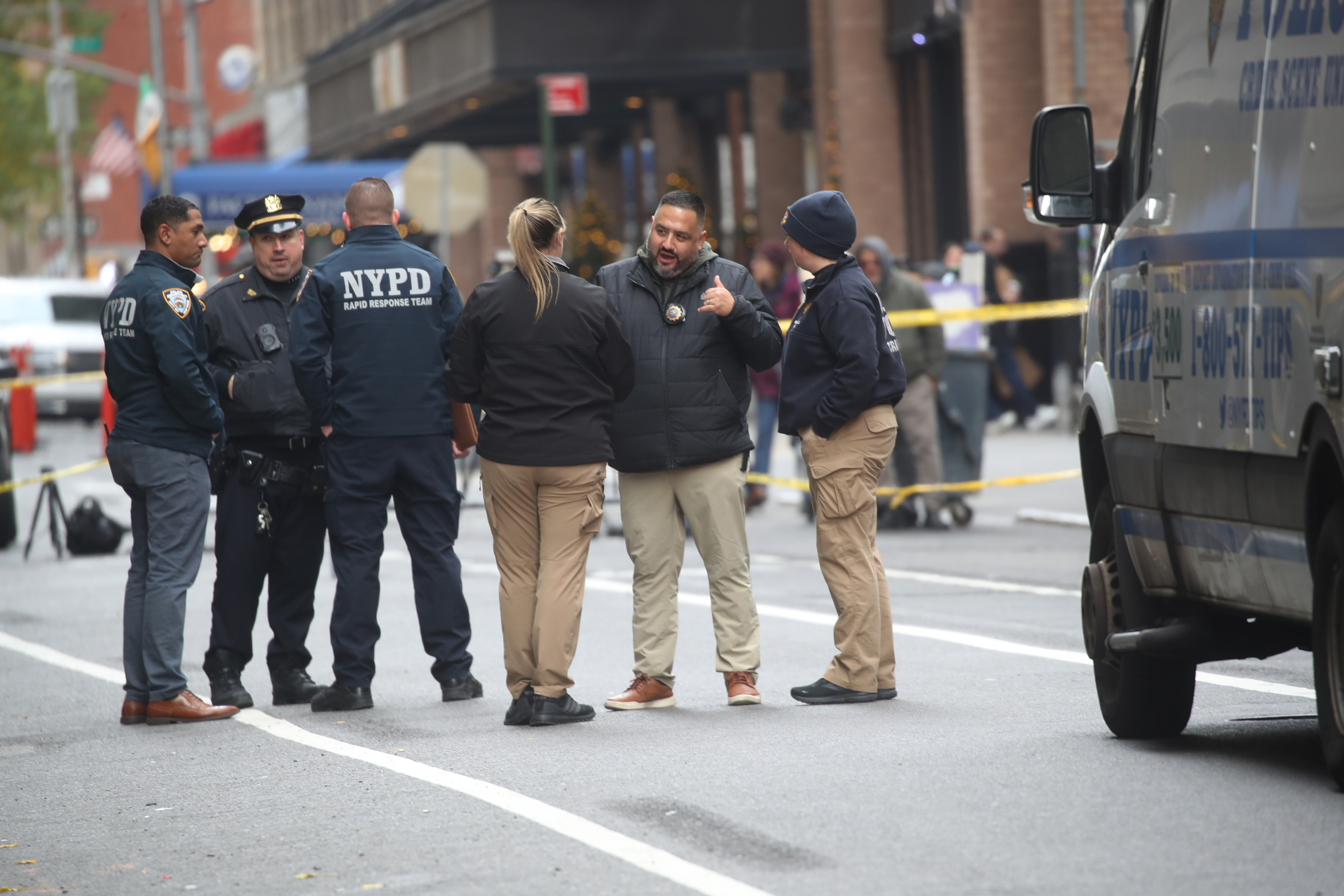 Police gather outside the Hilton Hotel in Midtown Manhattan, where UnitedHealthcare CEO Brian Thompson was fatally shot on December 4, 2024 | Source: Getty Images