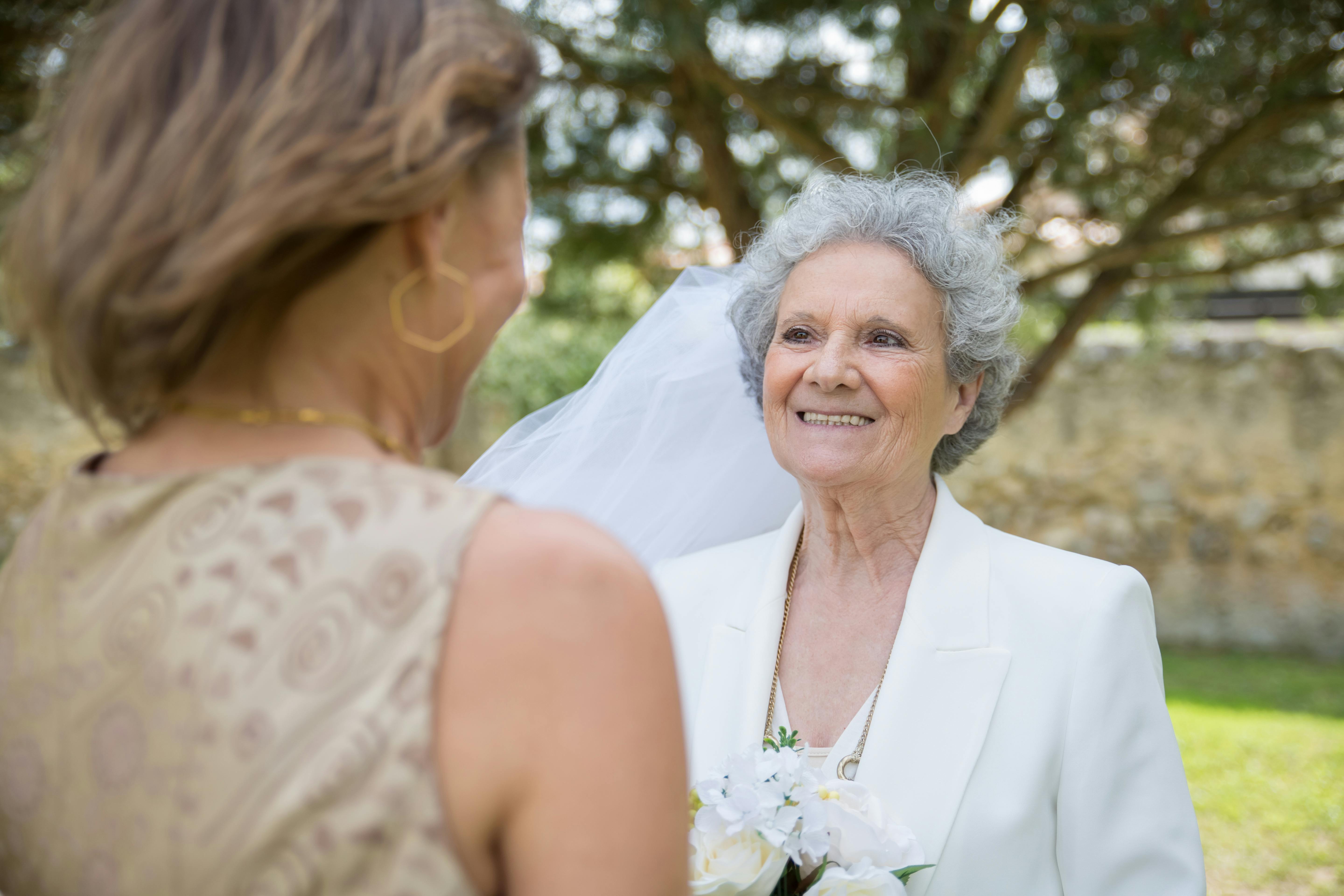 A woman in a wedding gown talking to a bridesmaid | Source: Pexels