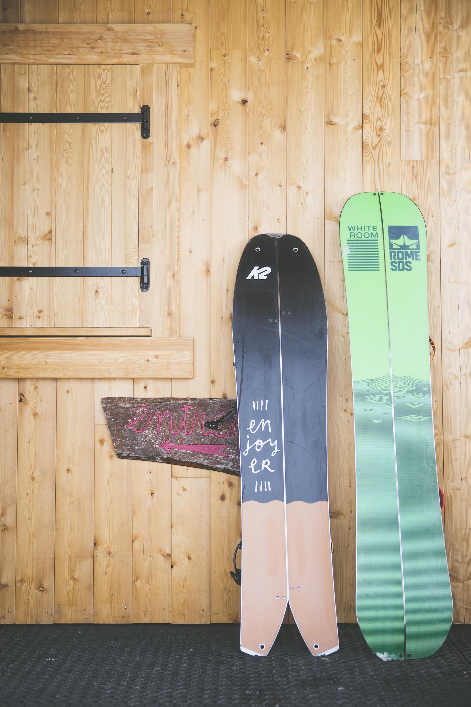 Two splitboards resting against a wooden surface. | Source: Getty Images