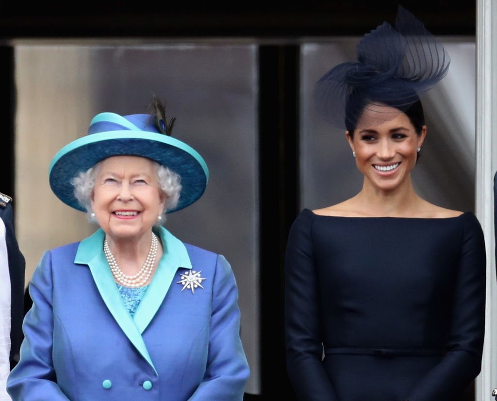 Queen Elizabeth II and Meghan, Duchess of Sussex watch the RAF flypast on the balcony of Buckingham Palace, as members of the Royal Family attend events to mark the centenary of the RAF | Photo: Getty Images