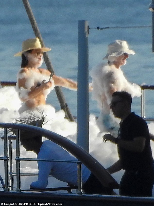 Pictures obtained by DailyMail.com of the lavish celebration show the loved-up couple covered in soap suds and all smiles as they relished in the summer sunshine