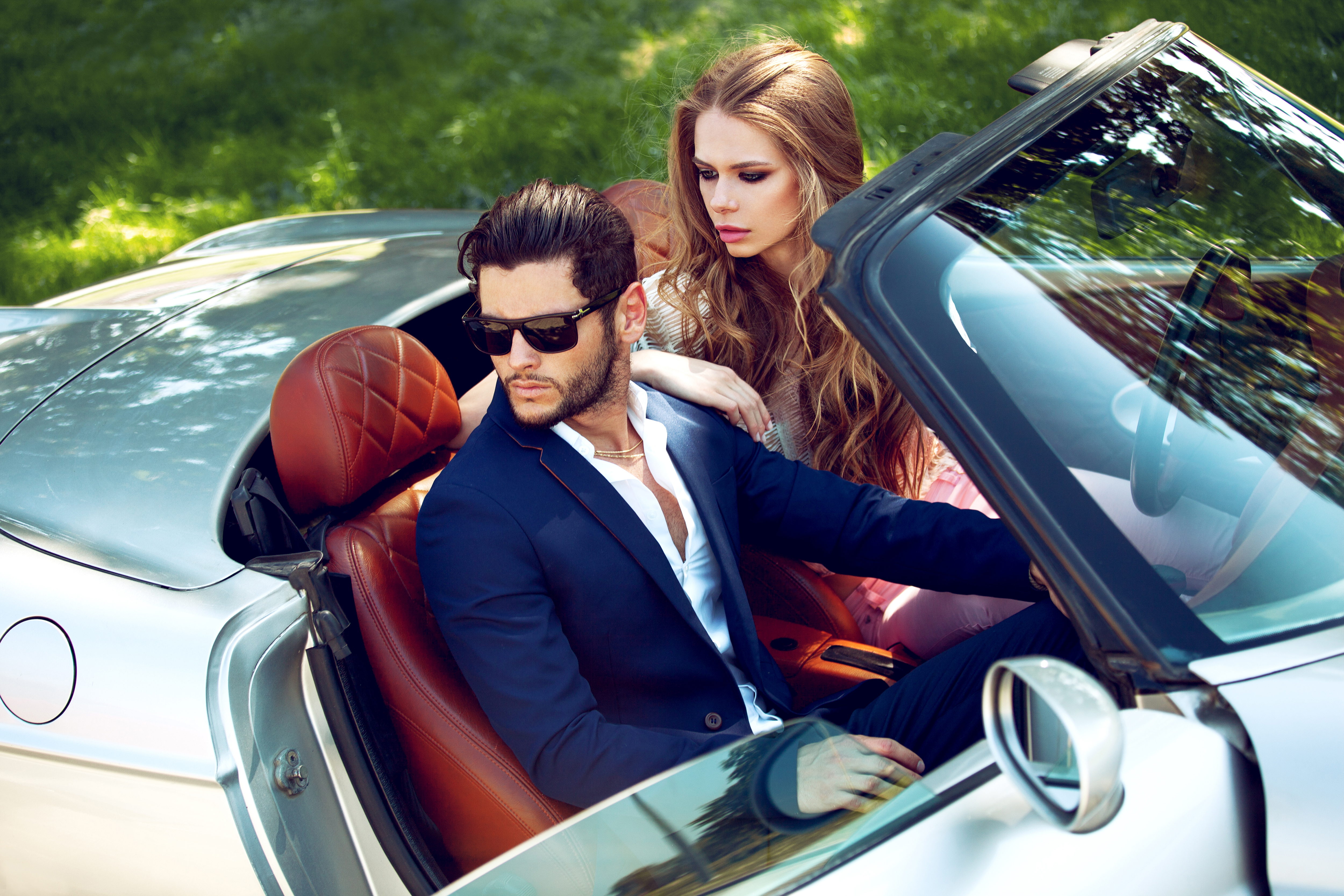 A young couple in a luxurious car | Source: Shutterstock