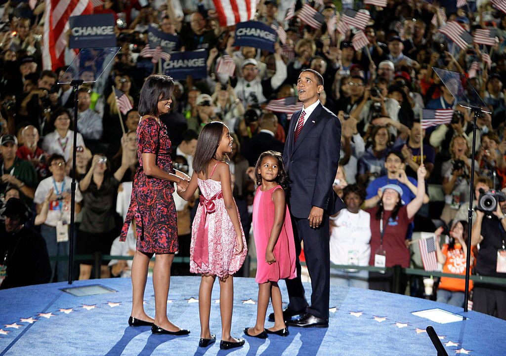 Michelle Obama, Malia Obama, Sasha Obama and U.S. Sen. Barack Obama stand on stage delegates after he accepted the Democratic presidential nomination at Invesco Field at Mile High | Getty Images 