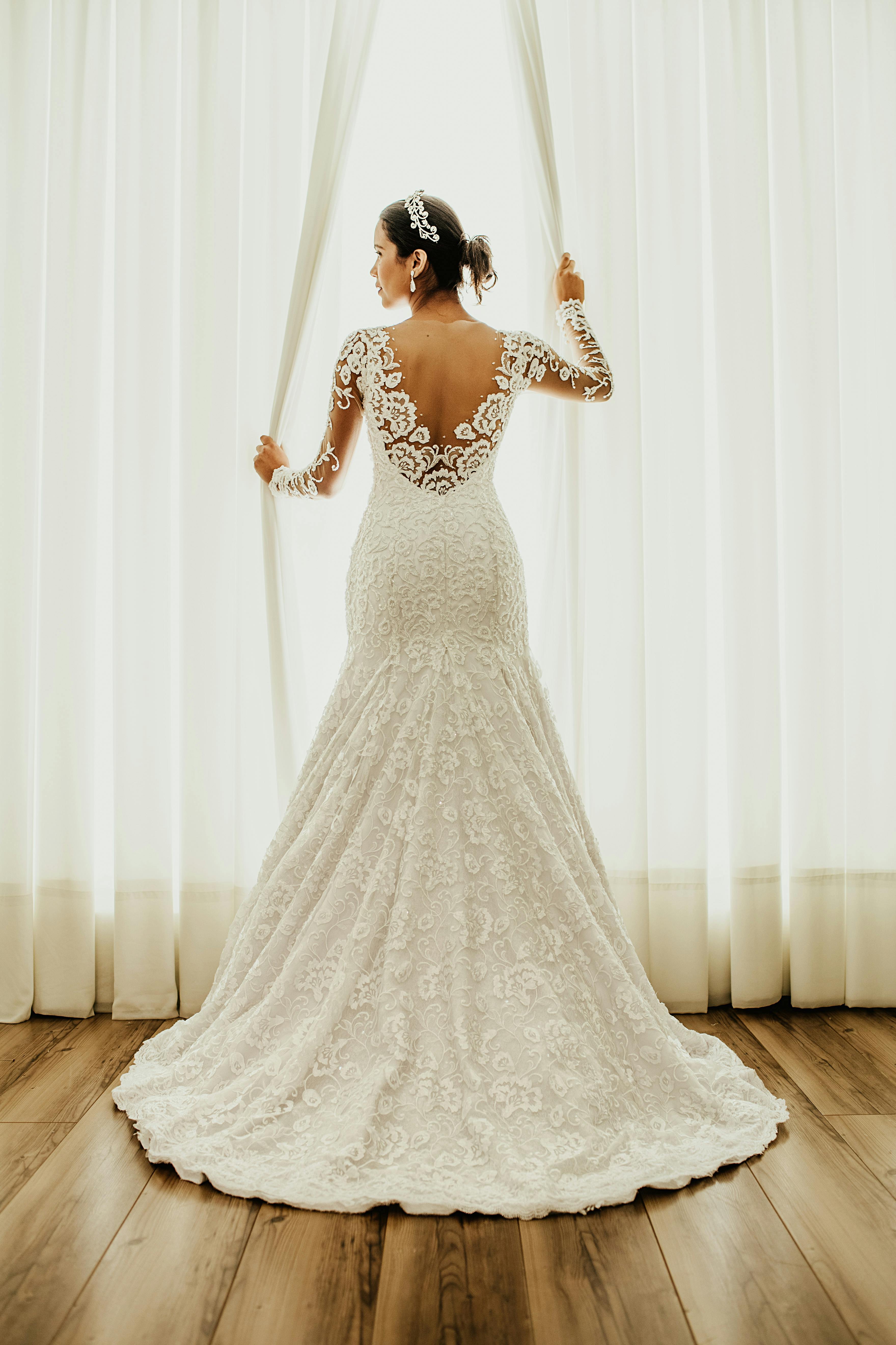 Beautiful bride standing near window and looking away | Source: Pexels