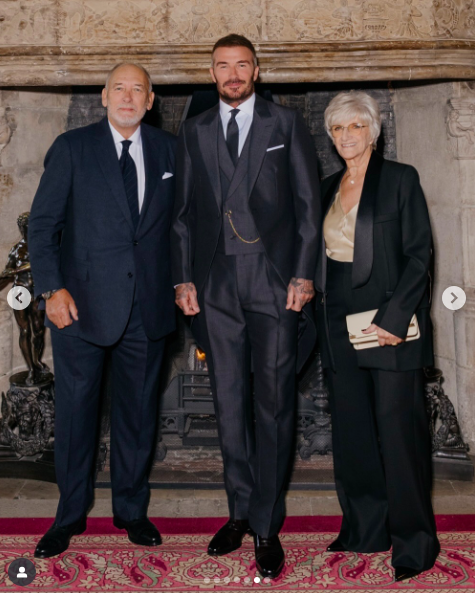 Ted, David, and Sandra Beckham posing during David's investiture. | Source: Instagram/victoriabeckham