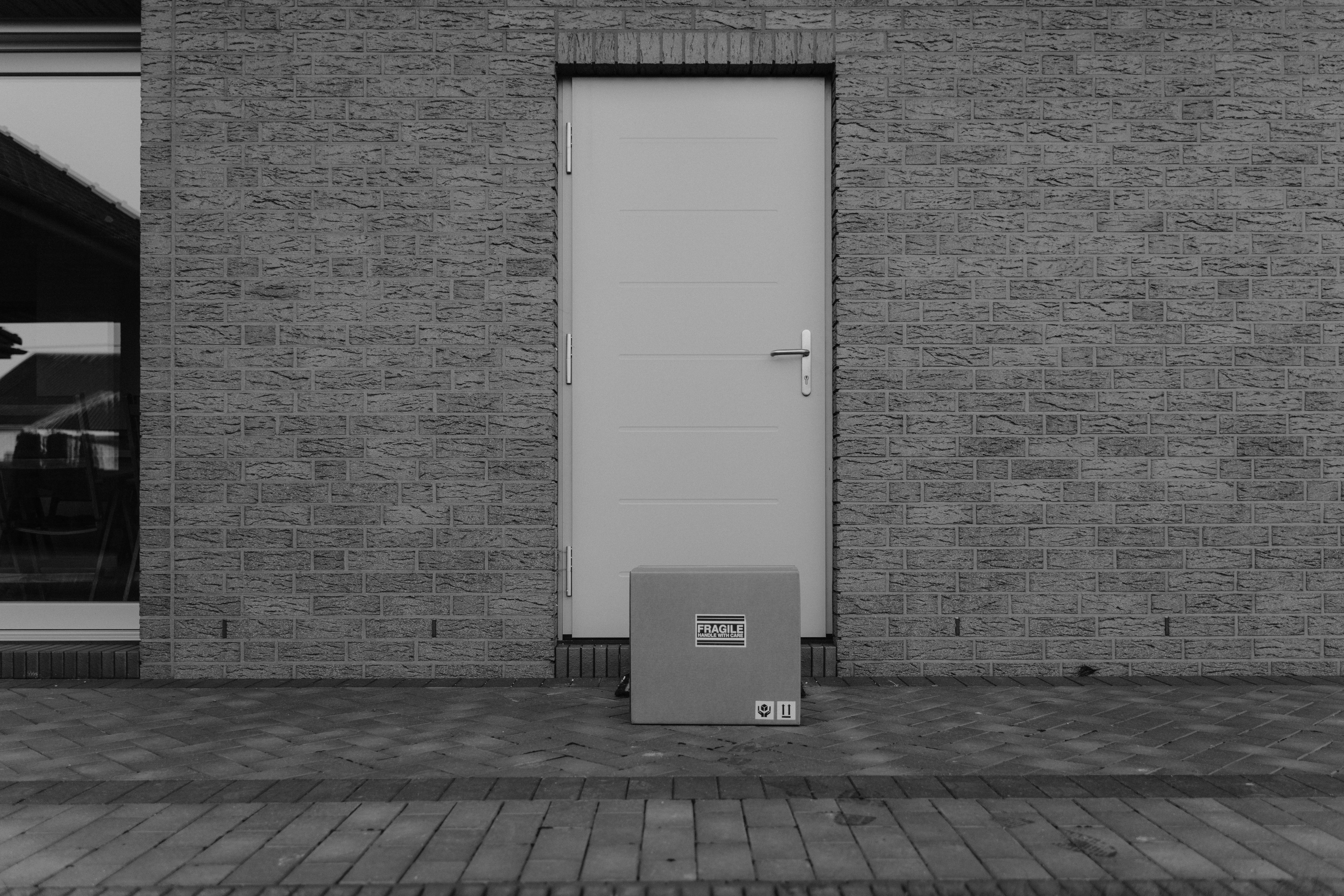 Package in front of a closed door. | Source: Pexels