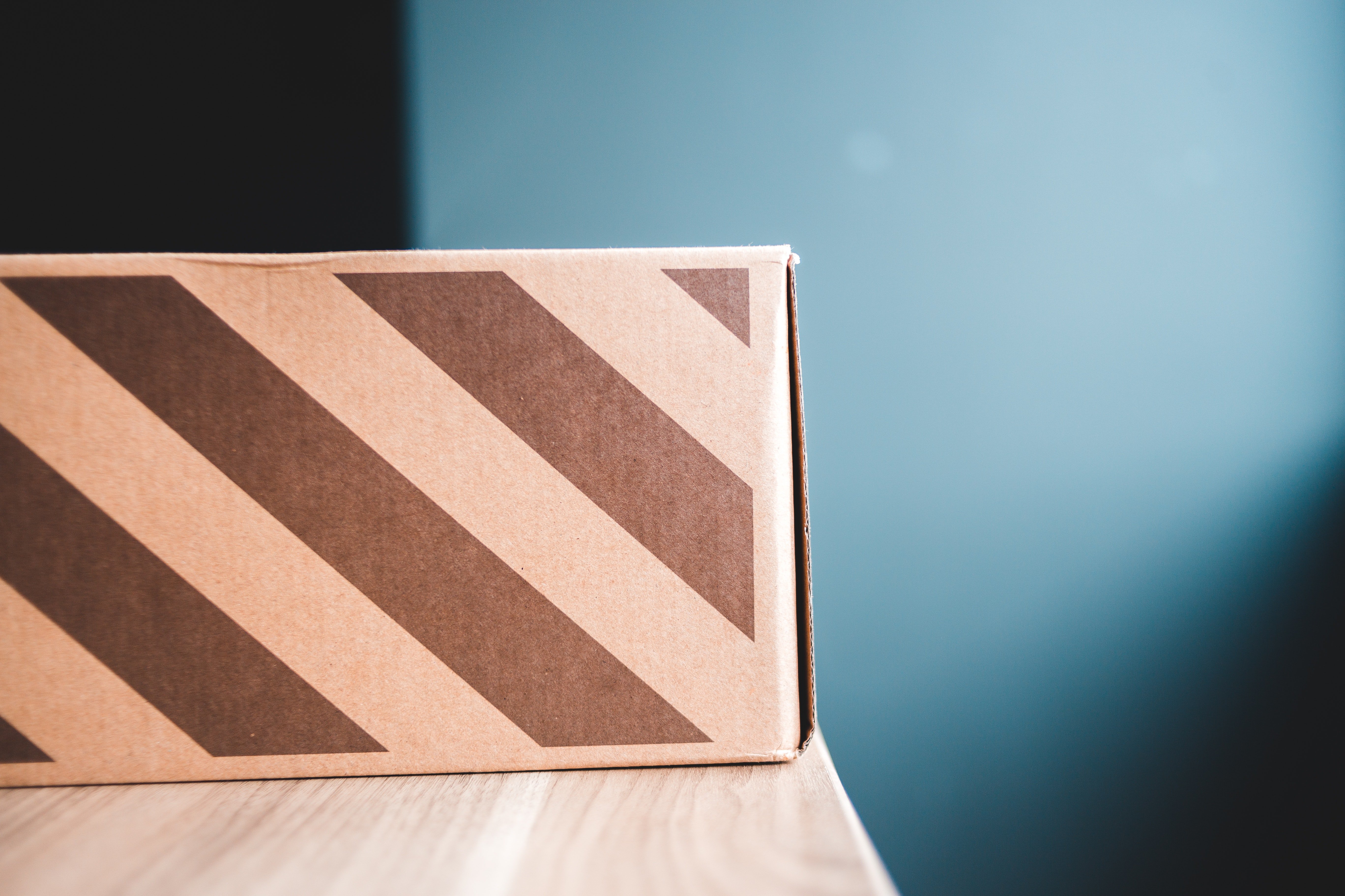 Cardboard box on table at home. | Source: Pexels