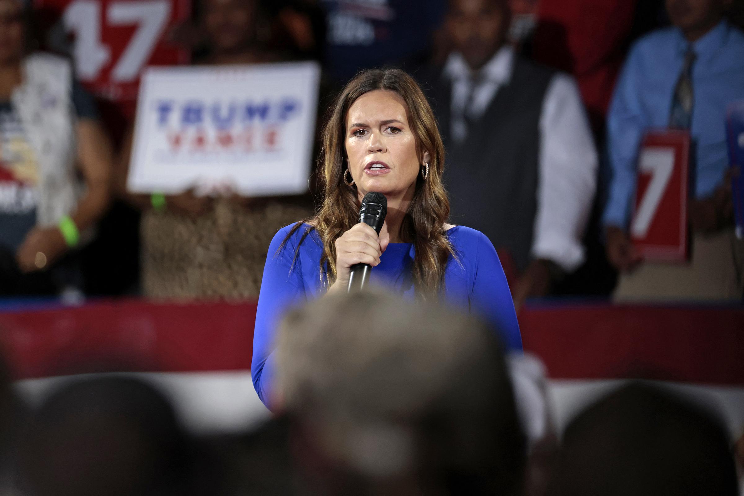 Arkansas Governor Sarah Huckabee Sanders moderates a town hall meeting with former US President and Republican presidential candidate Donald Trump at the Dort Financial Center on September 17, 2024, in Flint, Michigan. | Source: Getty Images