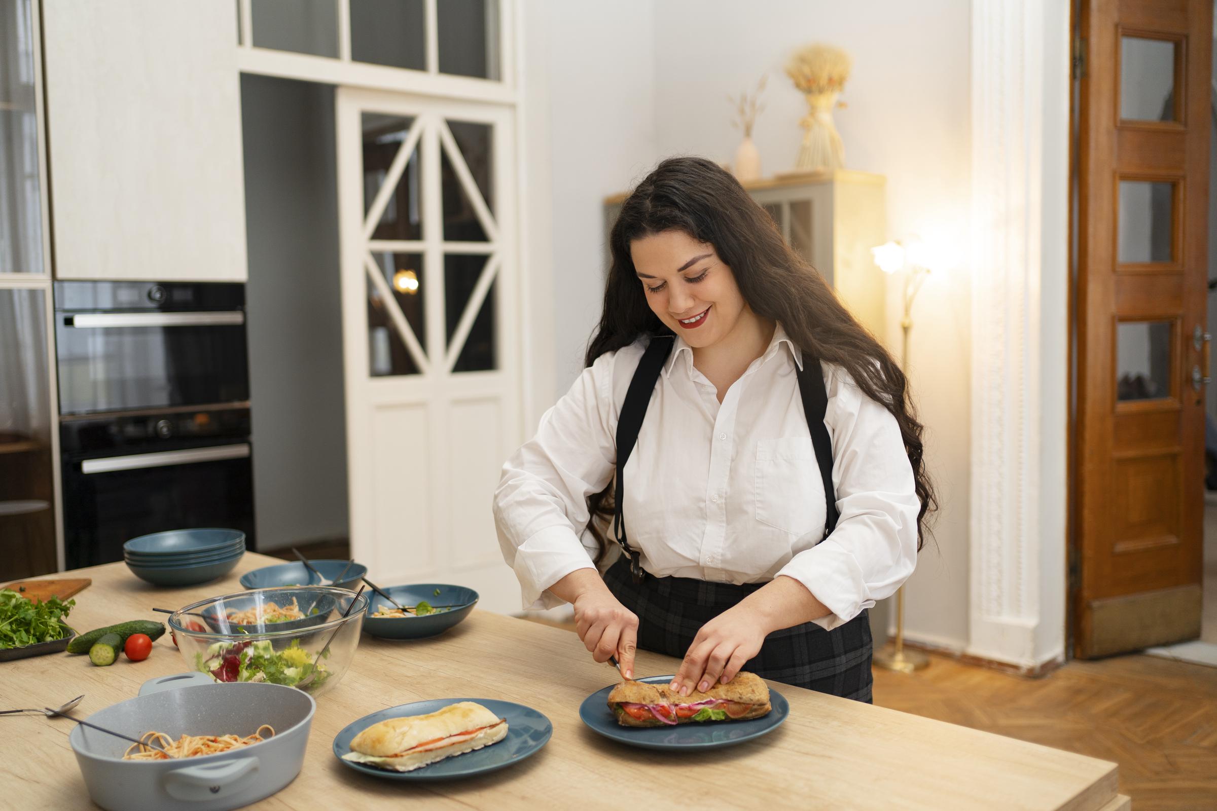 A happy woman cooking | Source: Freepik