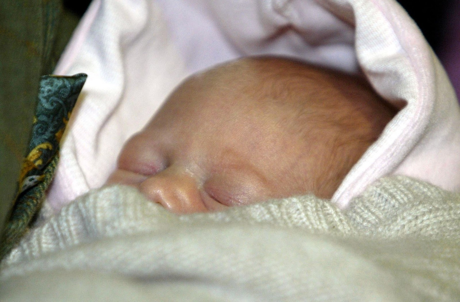 On November 23, 2003, Lady Louise was cradled in a blanket shortly after her premature birth. As she grew, her family ensured she had a balanced upbringing, instilling in her the values of humility and resilience. | Source: Getty Images