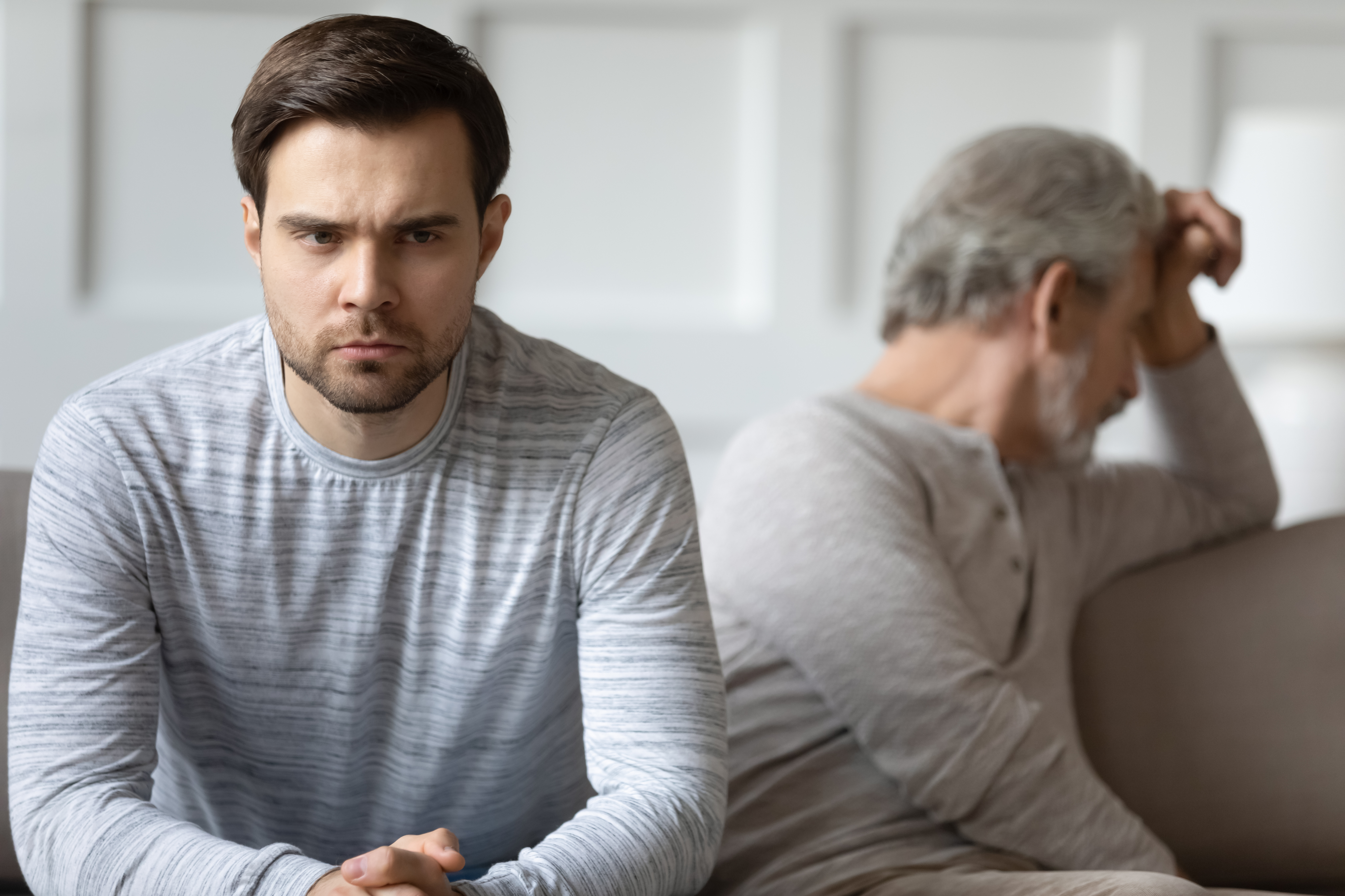 An upset man and an older man | Source: Shutterstock