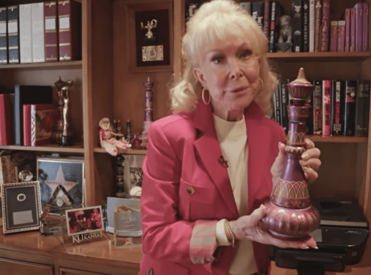 A picture of legendary entertainer, Barbara Eden showing off her collection of genie bottles | Photo: Youtube/PEOPLE