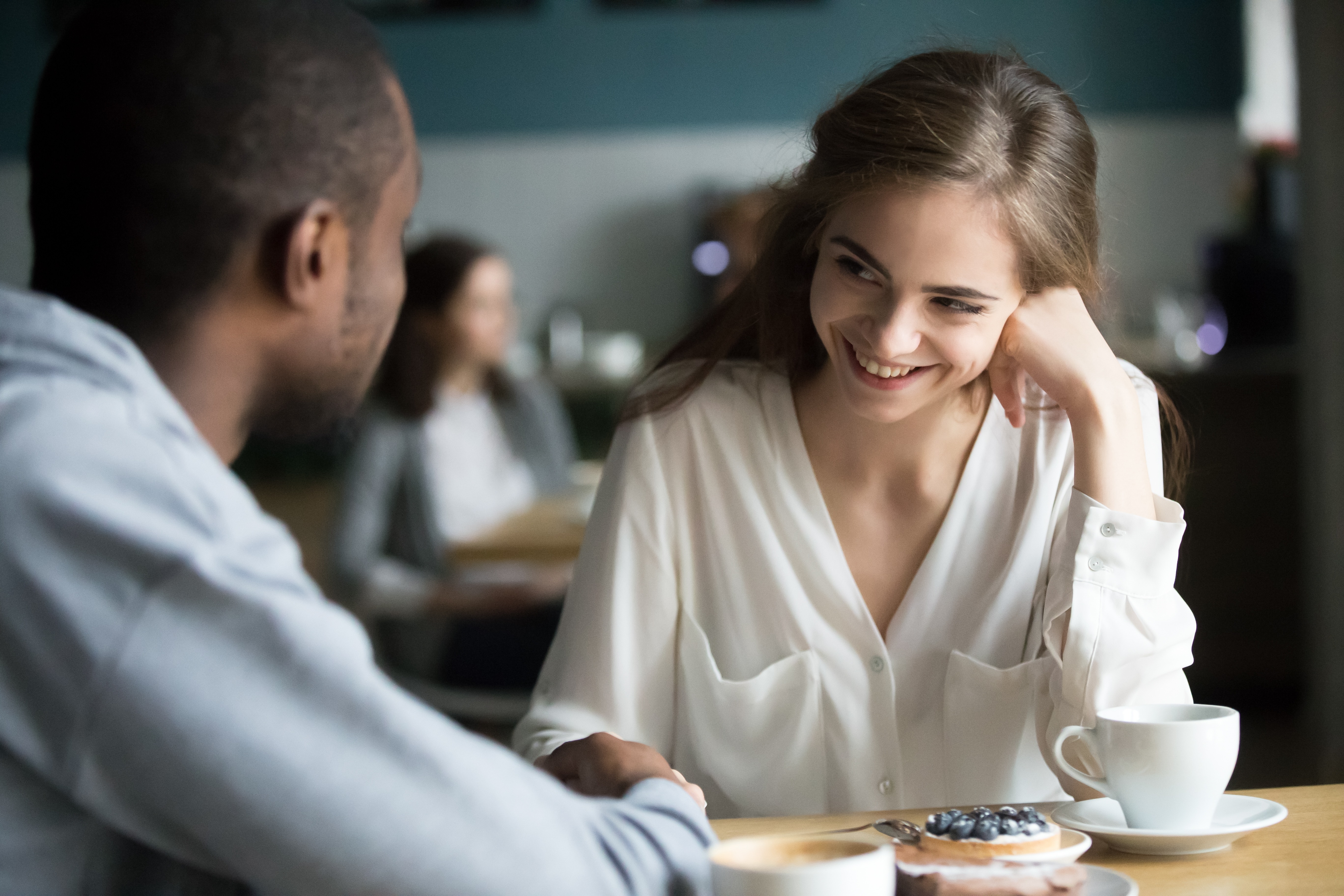 A happy couple flirting while on a date | Source: Shutterstock