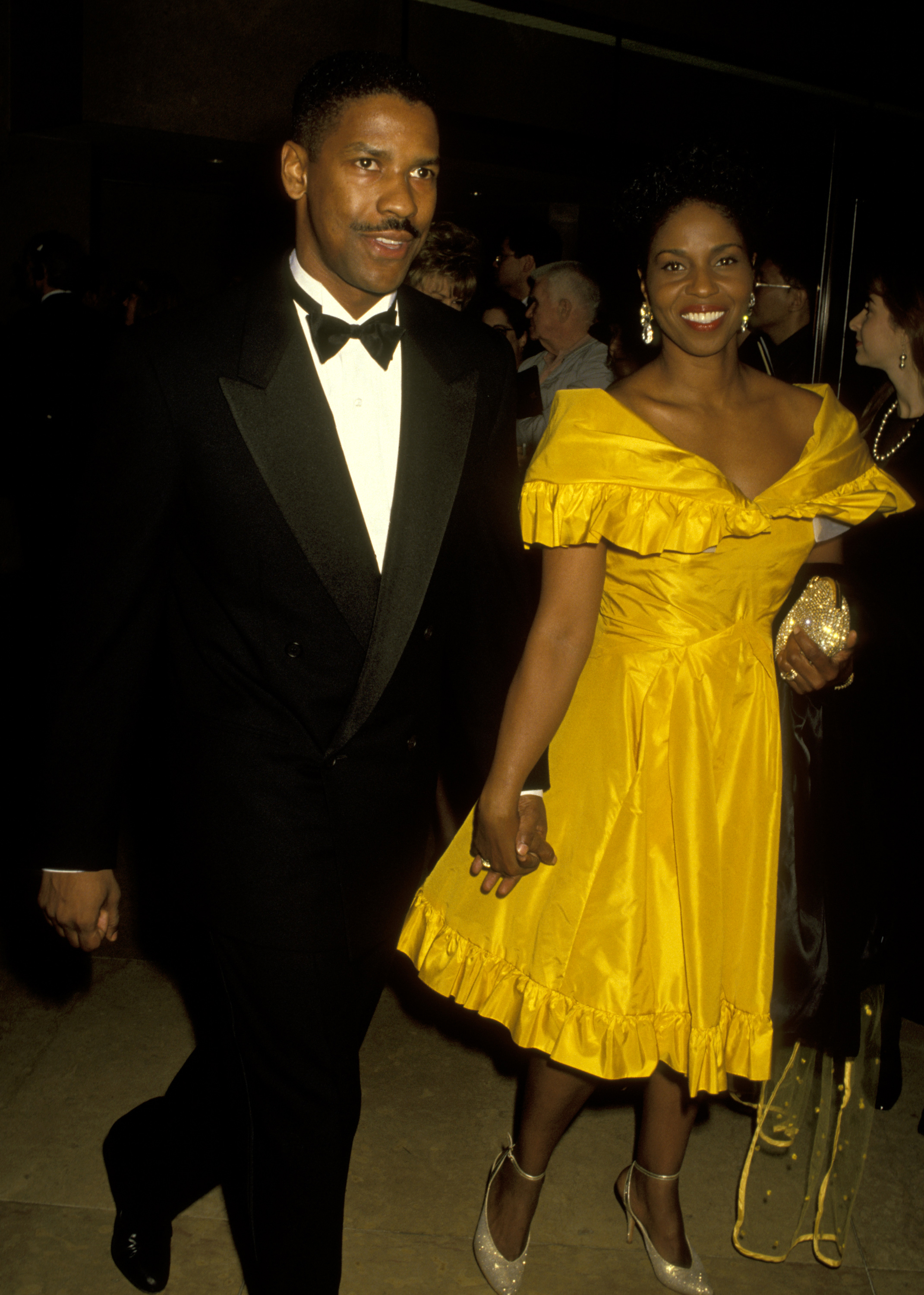 Denzel Washington attends the AFI Life Achievement Awards honoring Sidney Poitier with his wife Pauletta Washington. Wearing a tux and rocking his signature mustache, the actor keeps his hair neatly tapered for the elegant event.