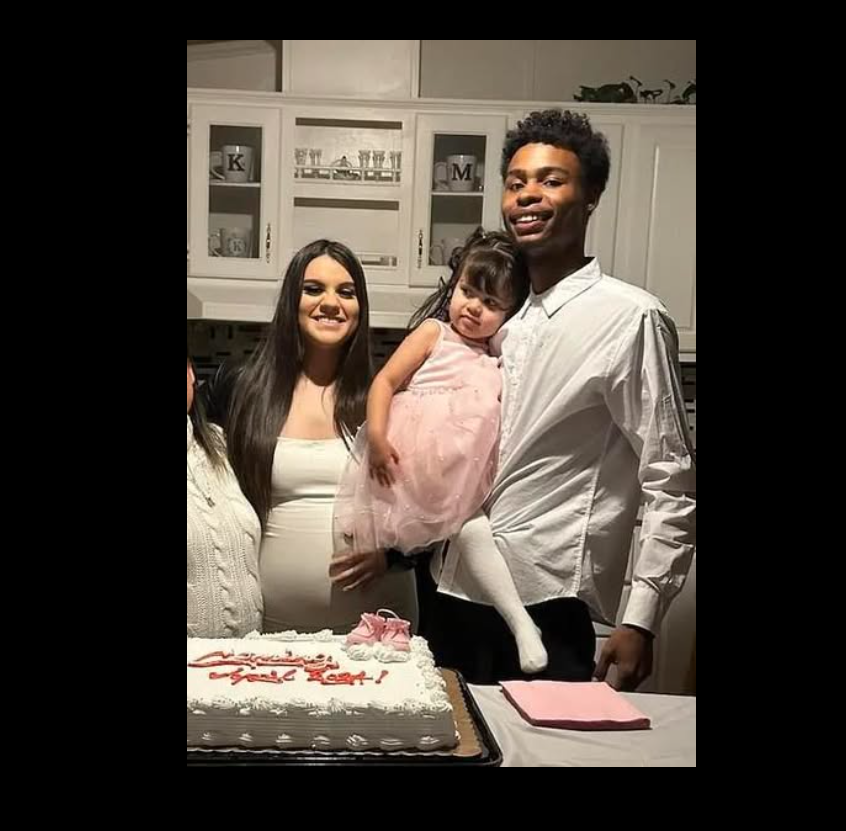 Klariza Tarango stands beside Devante Griffin as he holds young Kayce Griffin during a family gathering. | Source: Facebook/Jade Charde’