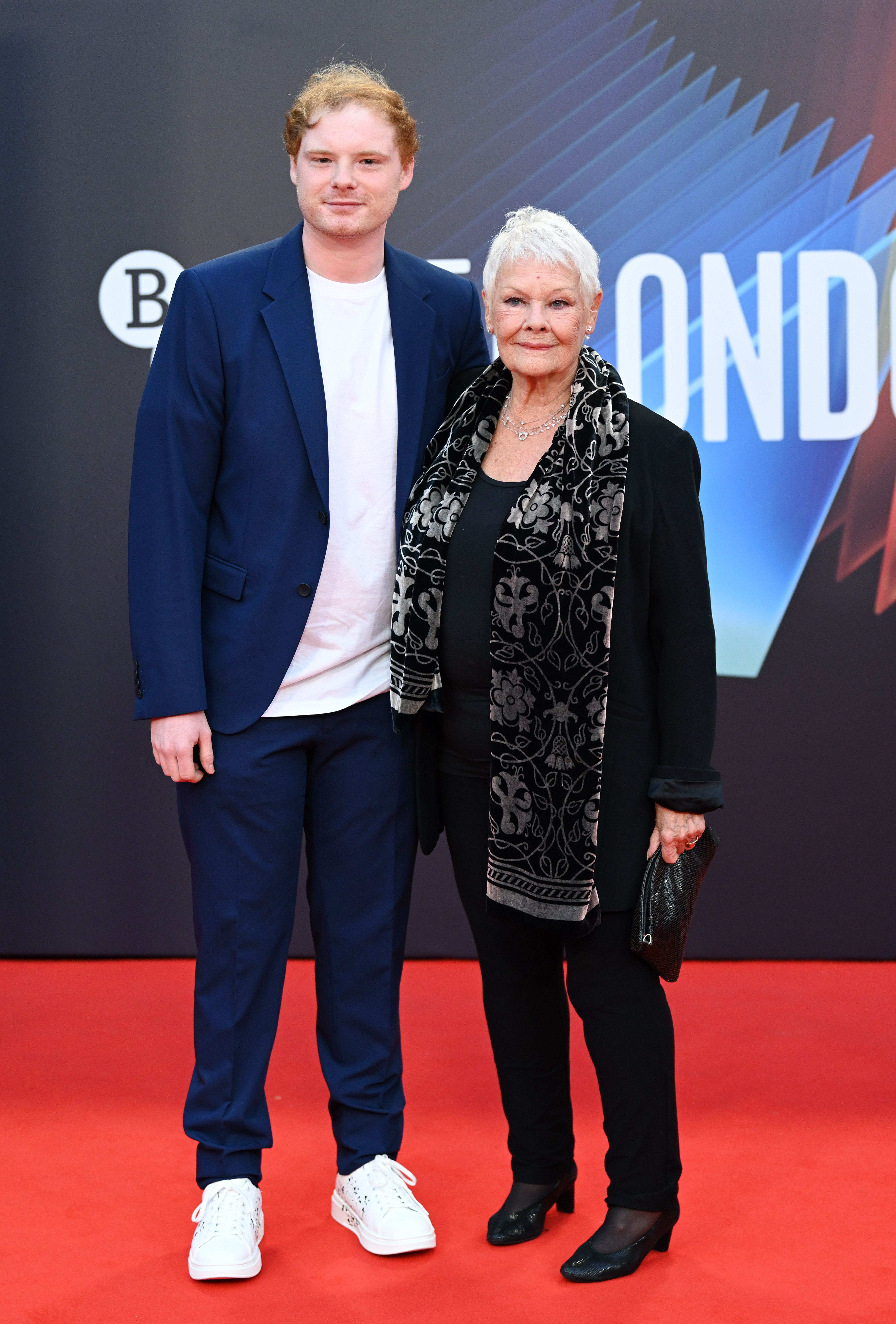 Dame Judi Dench and Sam Williams attend the "Belfast" European Premiere during the 65th BFI London Film Festival at The Royal Festival Hall in London, England on October 12, 2021. | Source: Getty Images