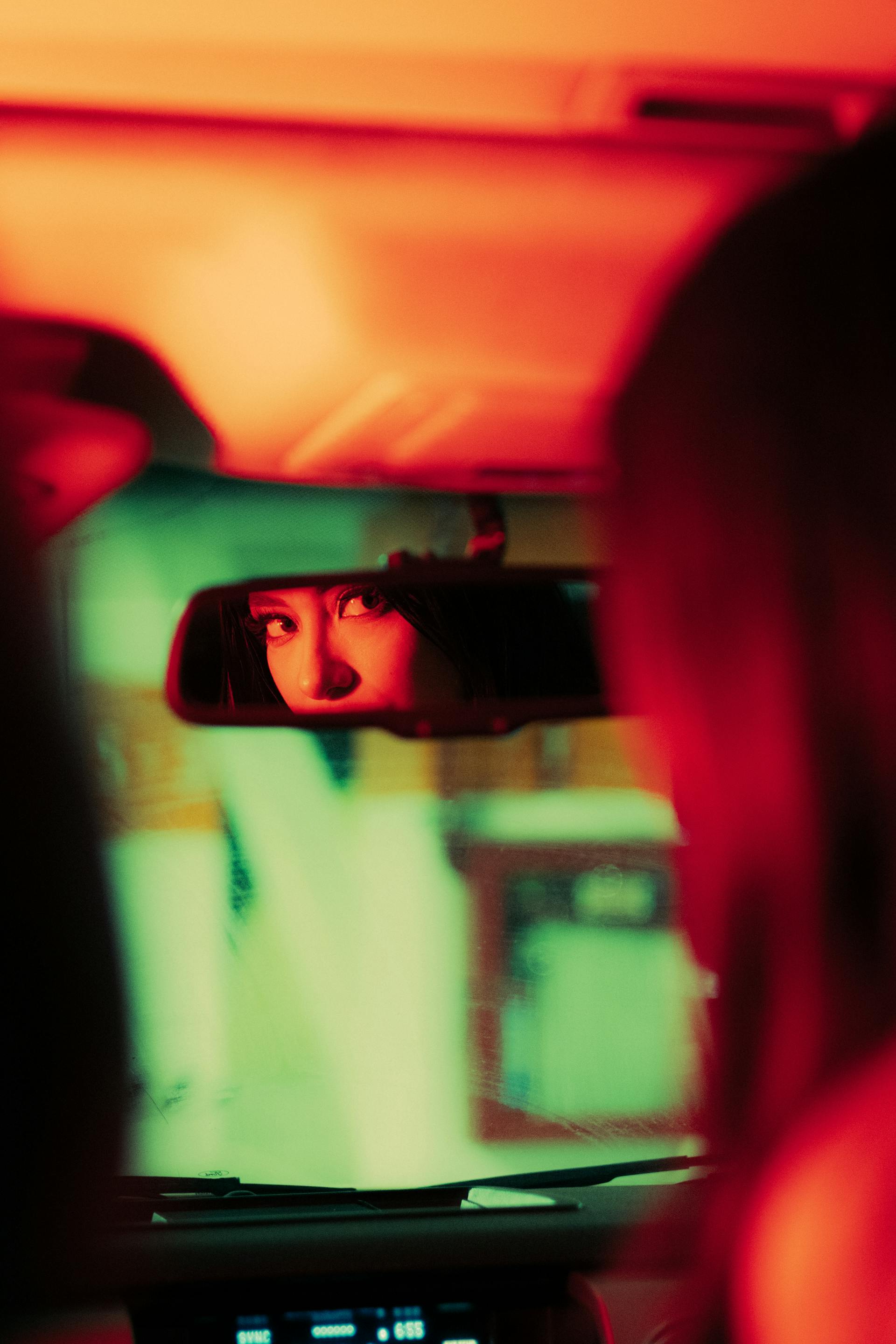 A woman's reflection in the rear-view mirror of a car | Source: Pexels