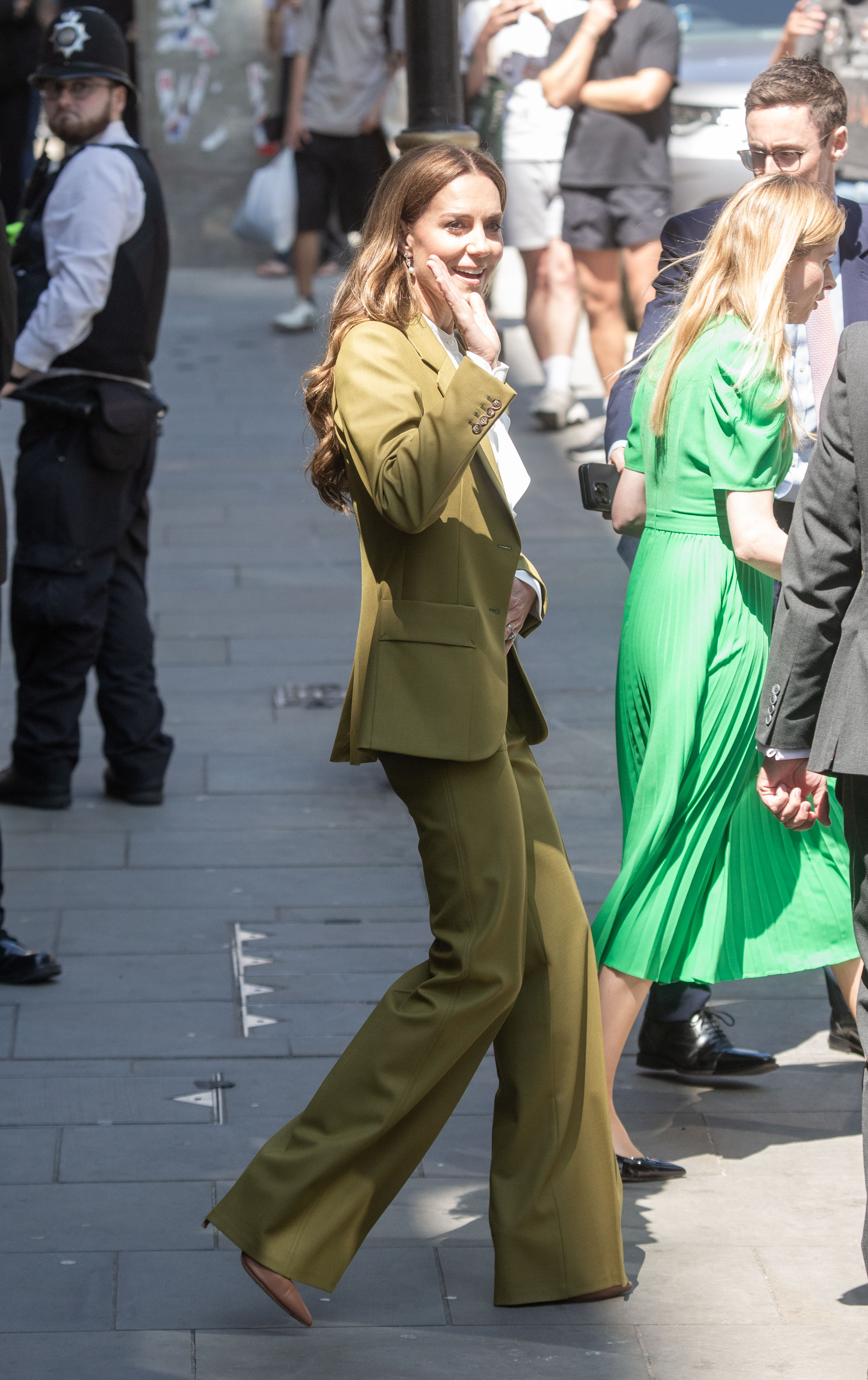 A side shot captures Catherine as she leaves the event, waving goodbye with a warm smile. She shows no hint of fatigue, only a sense of calm fulfillment spending time engaging with art and the creatives behind it.