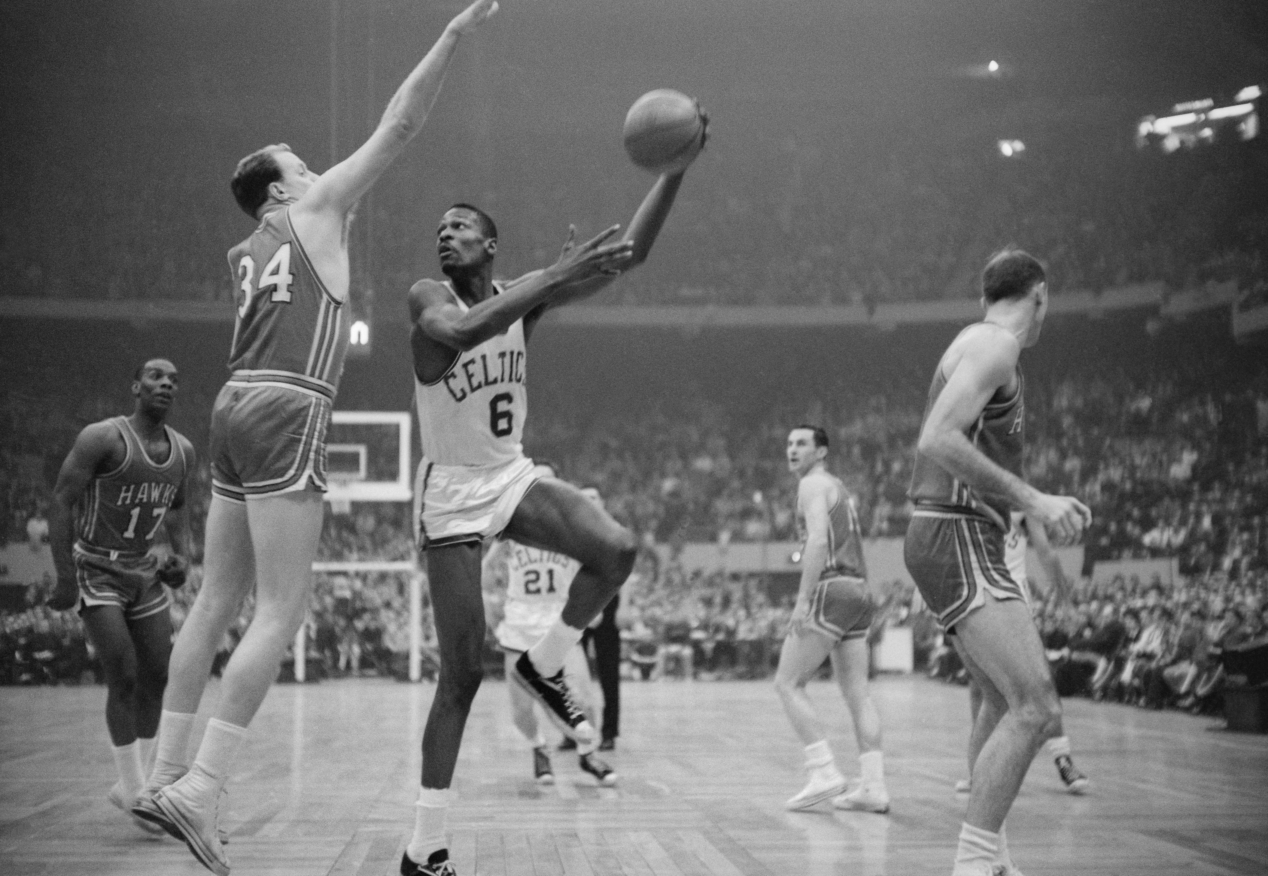 Bill Russell hooks a shot during the NBA championship's final game between the Boston Celtics and the Saint Louis Hawks in 1960. | Source: Getty Images