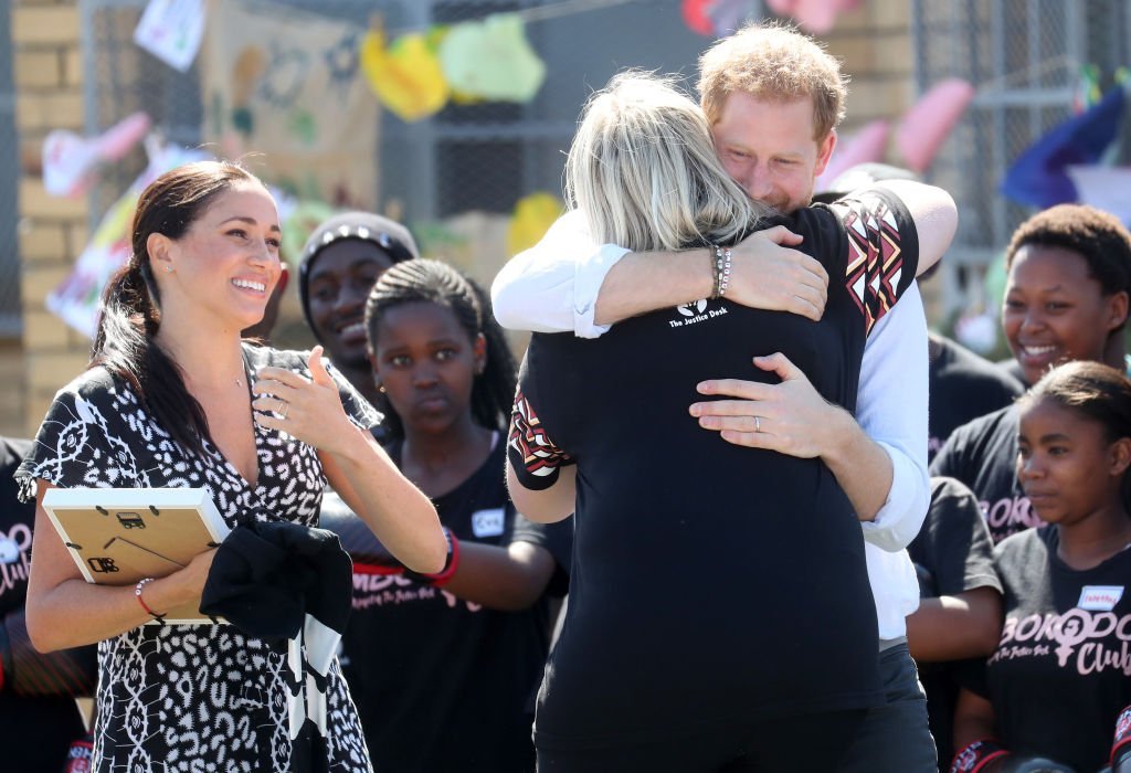 Prince Harry hugs Jessica Dewhurst, Justice Desk Founder, during the visit to a Justice Desk initiative in Nyanga township. | Source: Getty Images