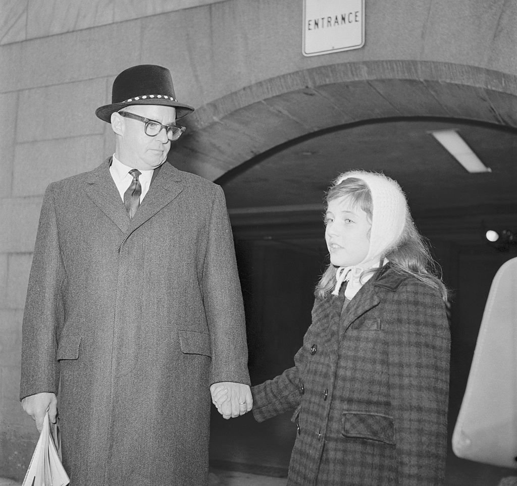 Patty Duke, 12, who won $32,000 as a contestant on the The $64,000 Challenge television program, shown with her manager John Ross leaving the house office building after Ross testified at a closed session of the House Legislative Oversight Subcommittee. | Source: Getty Images