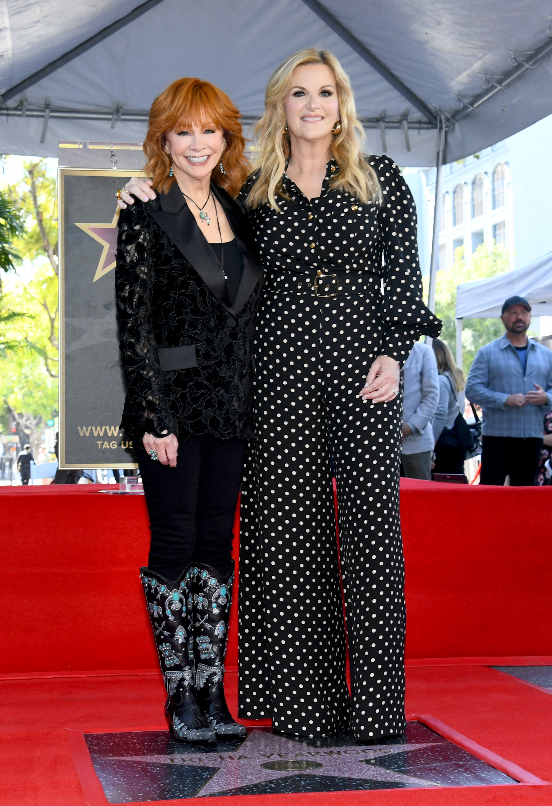 Reba McEntire and Trisha Yearwood pose onstage during the ceremony honoring Trisha Yearwood with a Star on the Hollywood Walk of Fame | Source: Getty Images