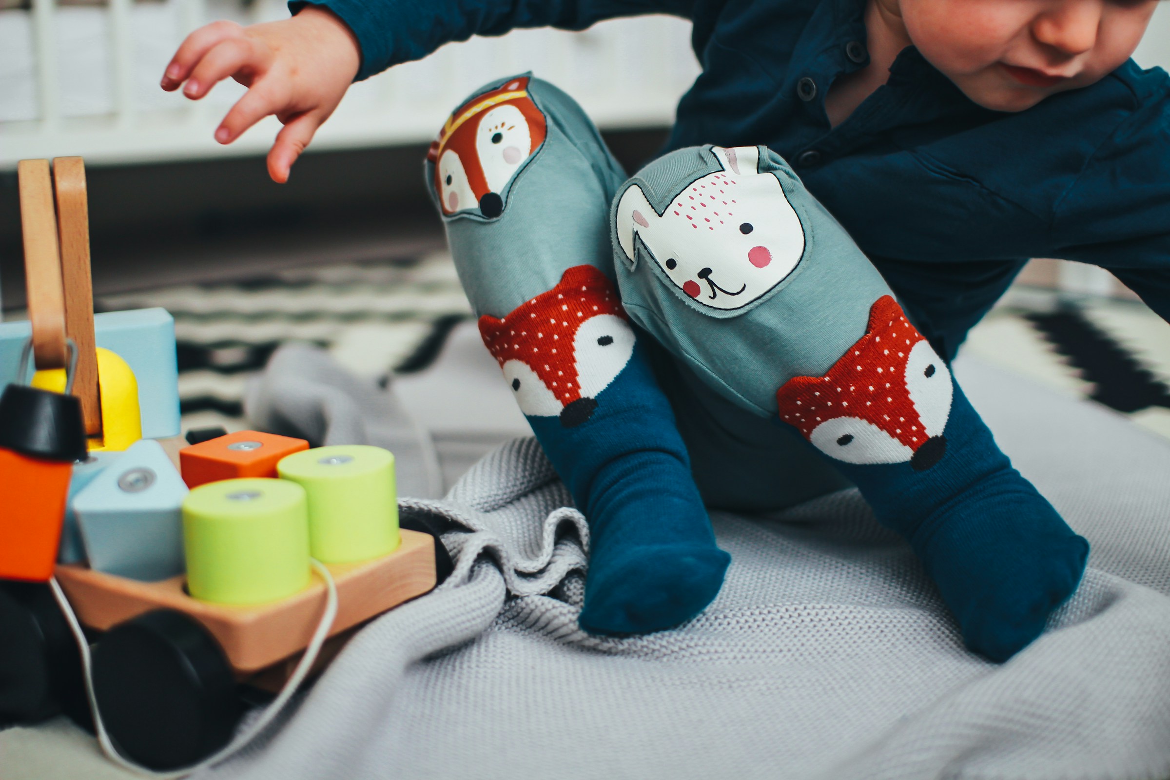 Close-up of a boy playing with toys | Source: Unsplash