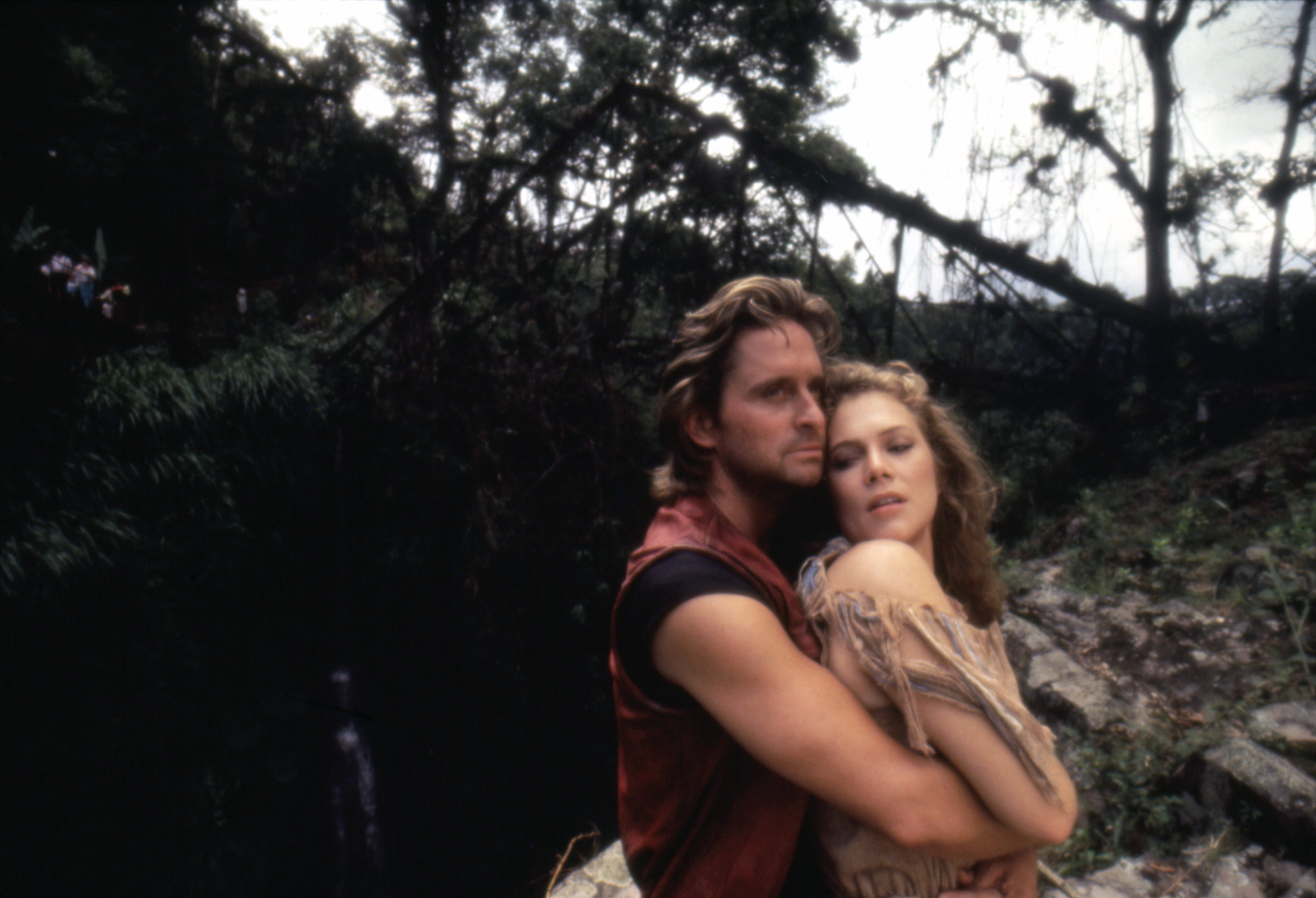 Michael Douglas and Kathleen Turner pictured in an embrace in the adventure film "Romancing the Stone." | Source: Getty Images