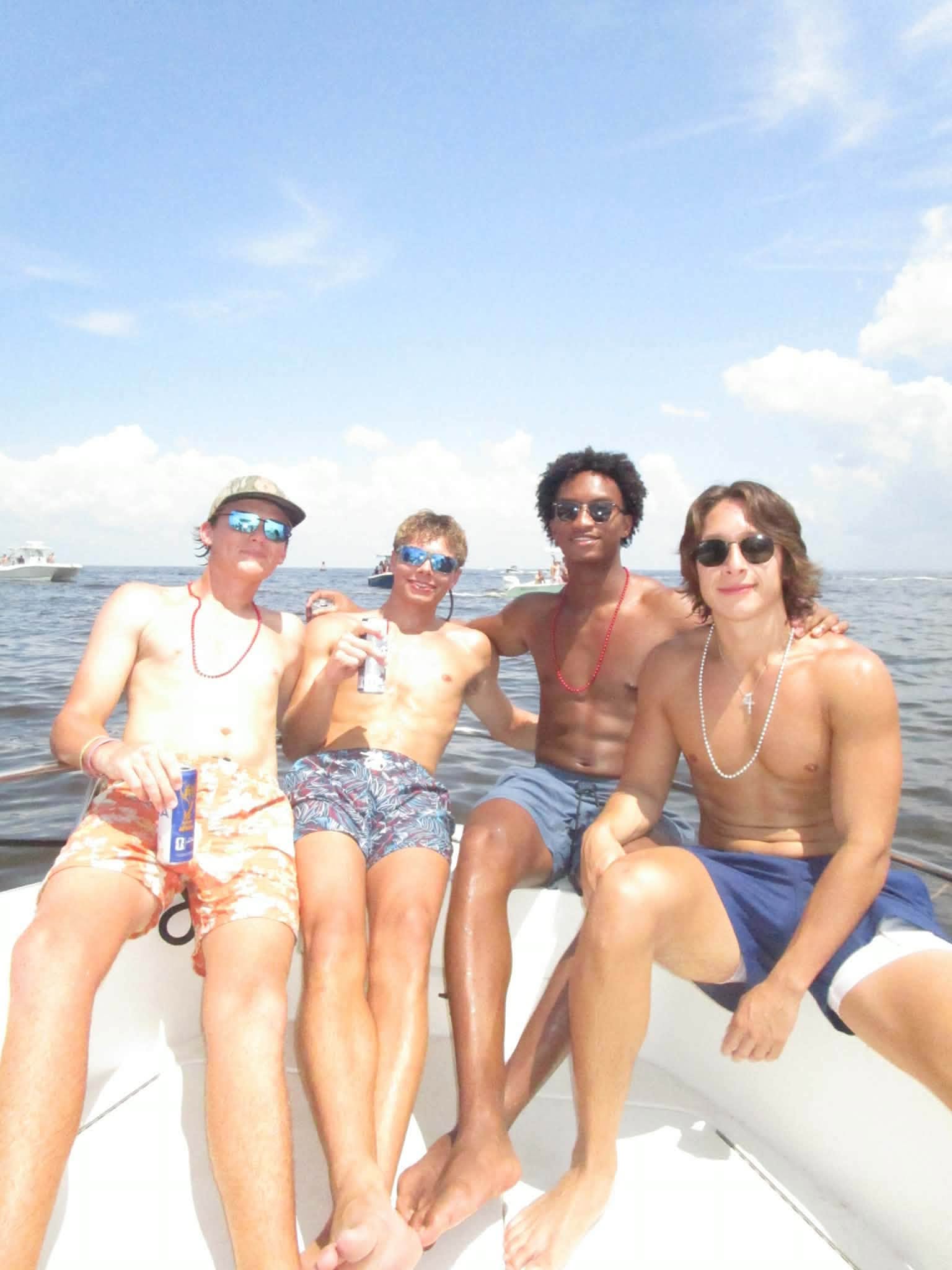 The tragic images show the young player smiling and posing happily with his three friends as they basked inside a boat earlier that day. | Source: Facebook/christine.wonsley