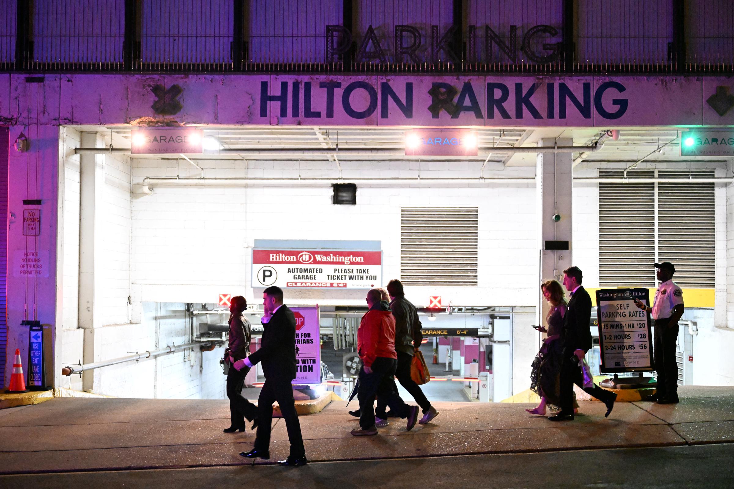 Guests walk past a garage at the Hilton Hotel during the White House Correspondents' dinner in Washington, DC, on April 25, 2026. | Source: Getty Images