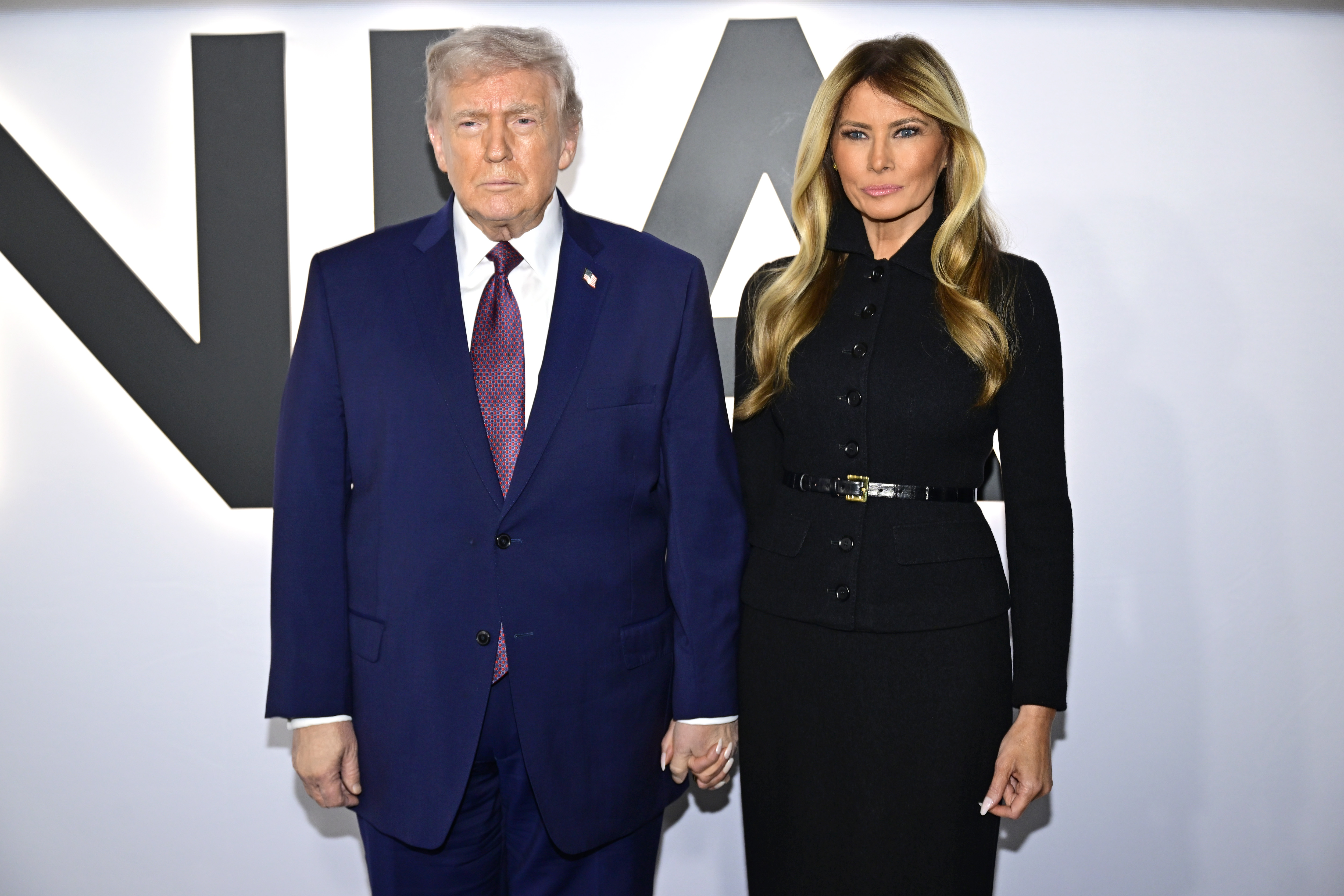 Donald and Melania Trump standing hand-in-hand as they pose for photos at the world premiere of "Melania" on January 29, 2026. | Source: Getty Images