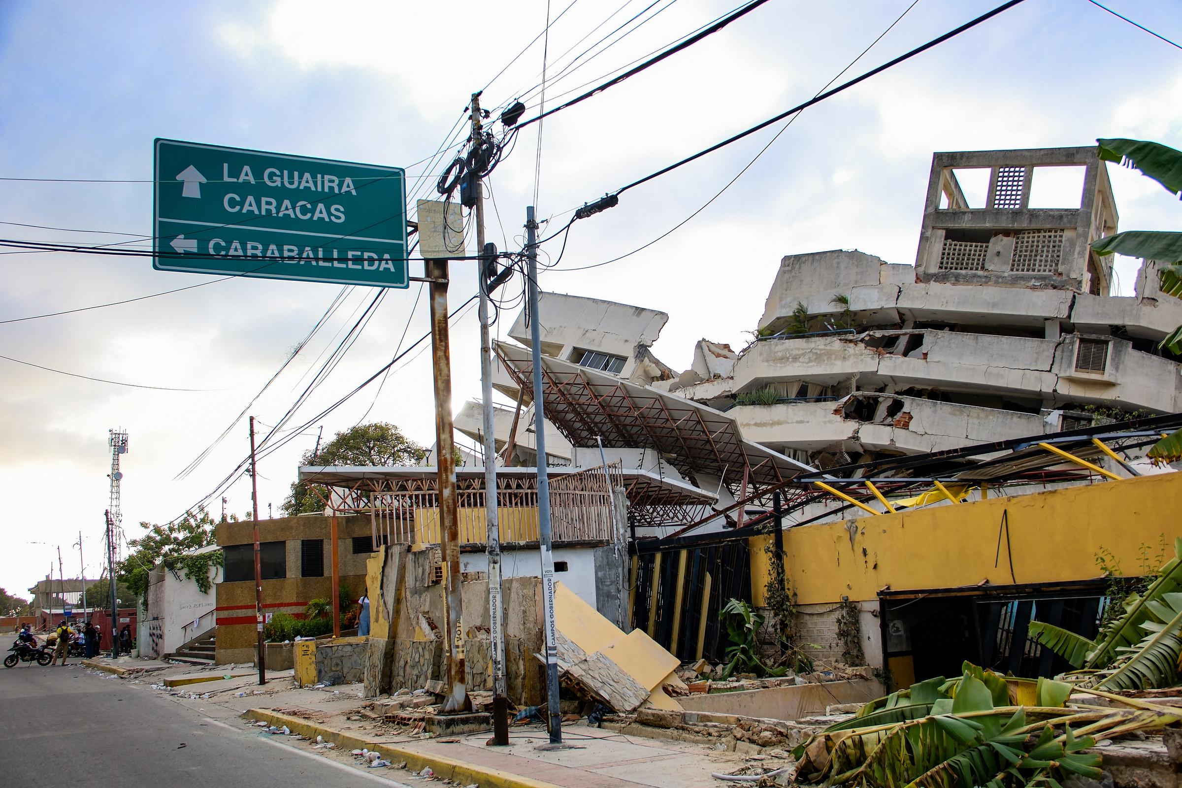 The earthquakes left entire buildings damaged or destroyed across La Guaira, where Trejo's family was trapped. Authorities later limited access to some roads so rescue crews and heavy equipment could reach disaster sites more quickly. | Source: Getty Images