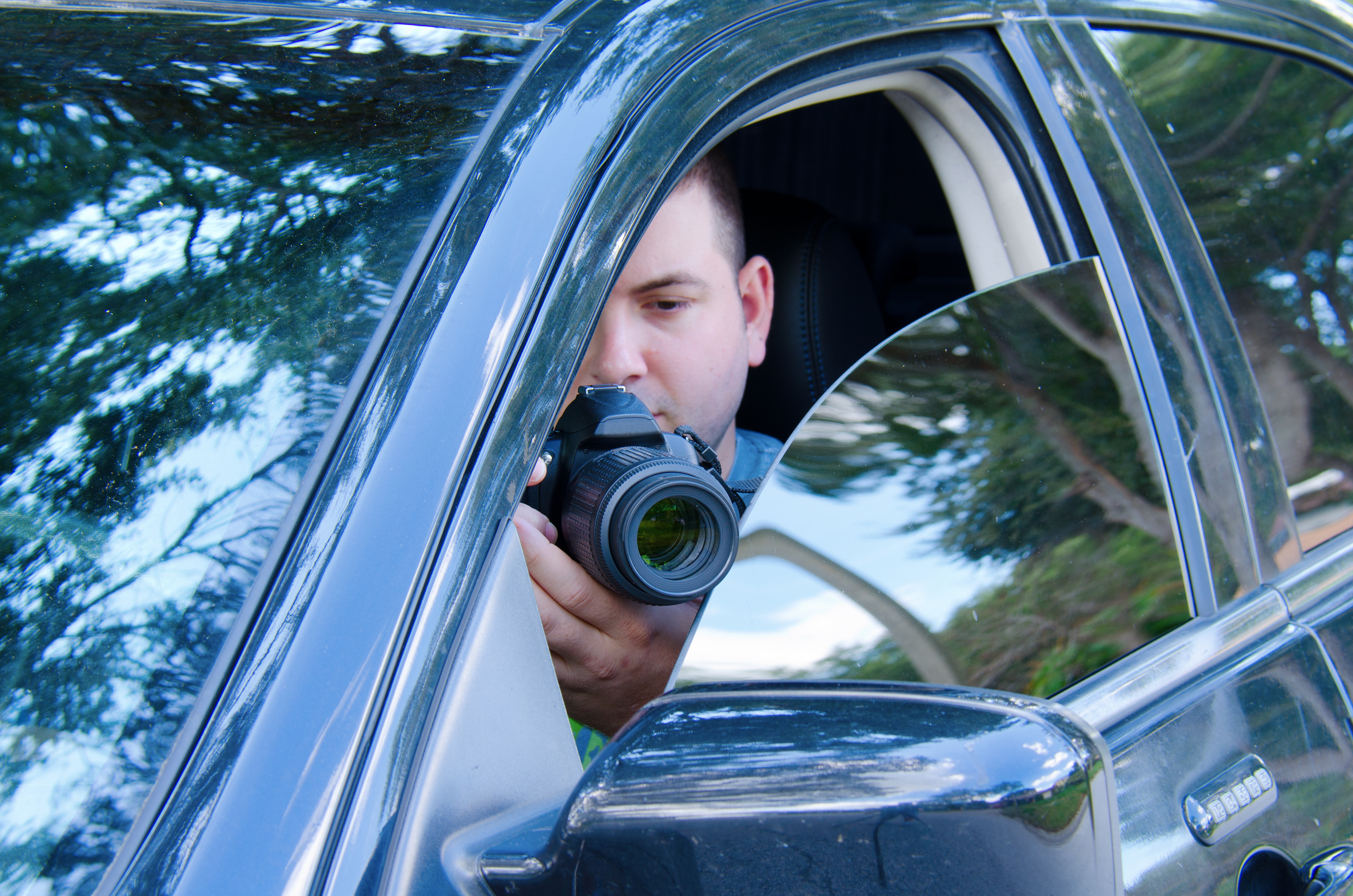 A man taking a photo from his car | Source: Shutterstock