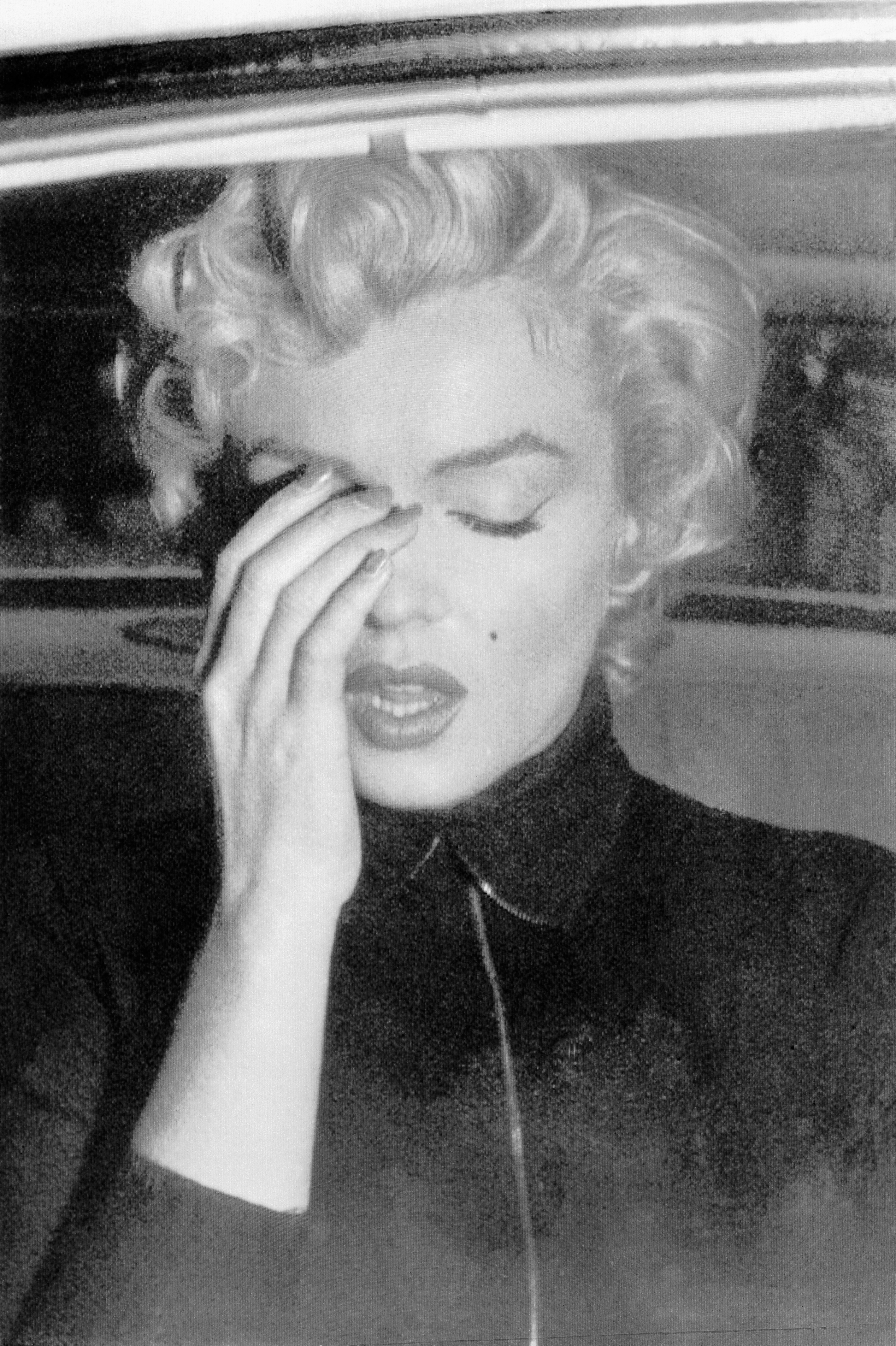 Marilyn Monroe seen crying in a car in Beverly Hills, California in 1954. | Source: Getty Images