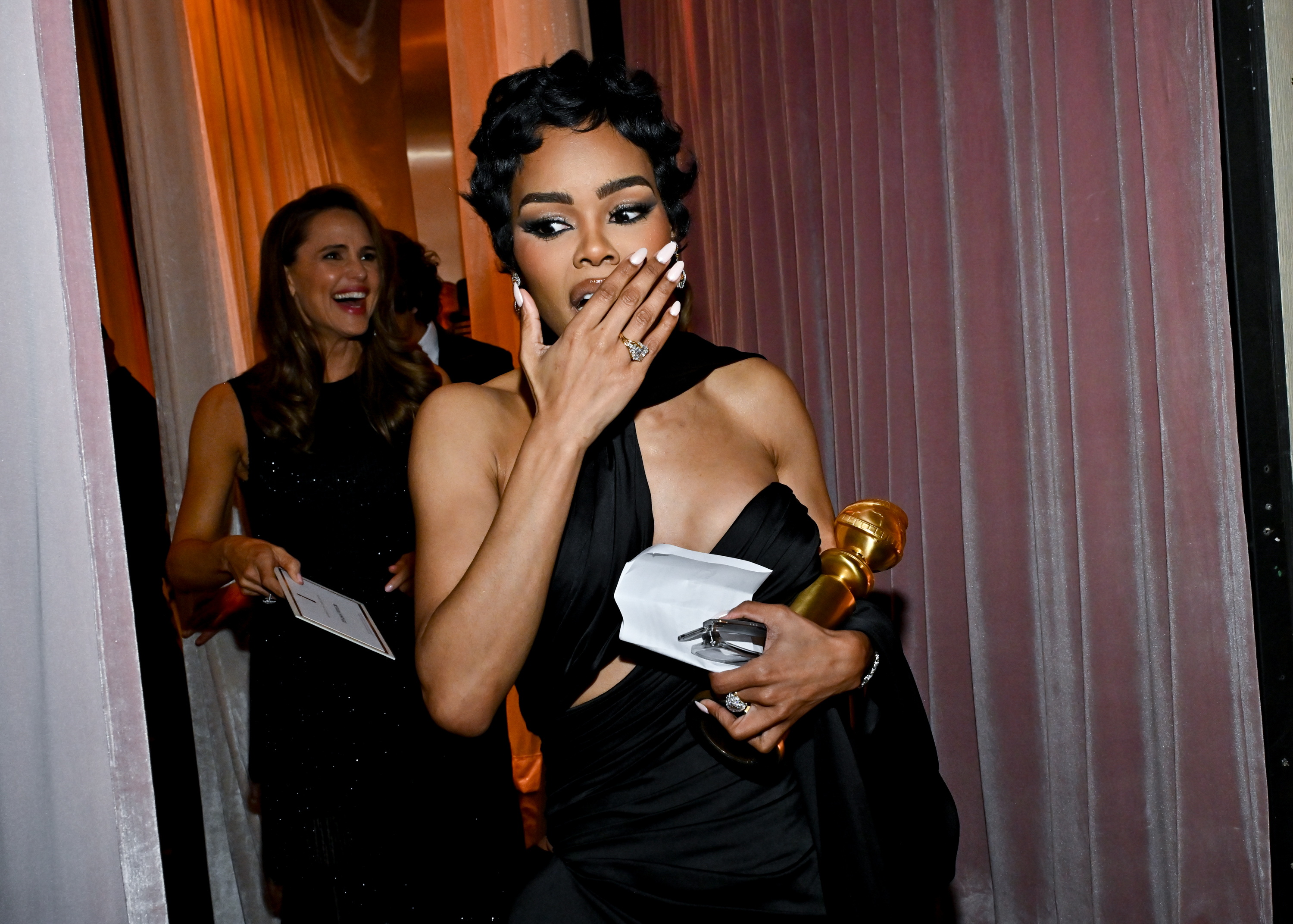 Teyana Taylor holds her Golden Globe tightly while appearing visibly emotional backstage. The actress was fresh off her historic win — and her briefly censored speech — as Jennifer Garner smiled supportively behind her.