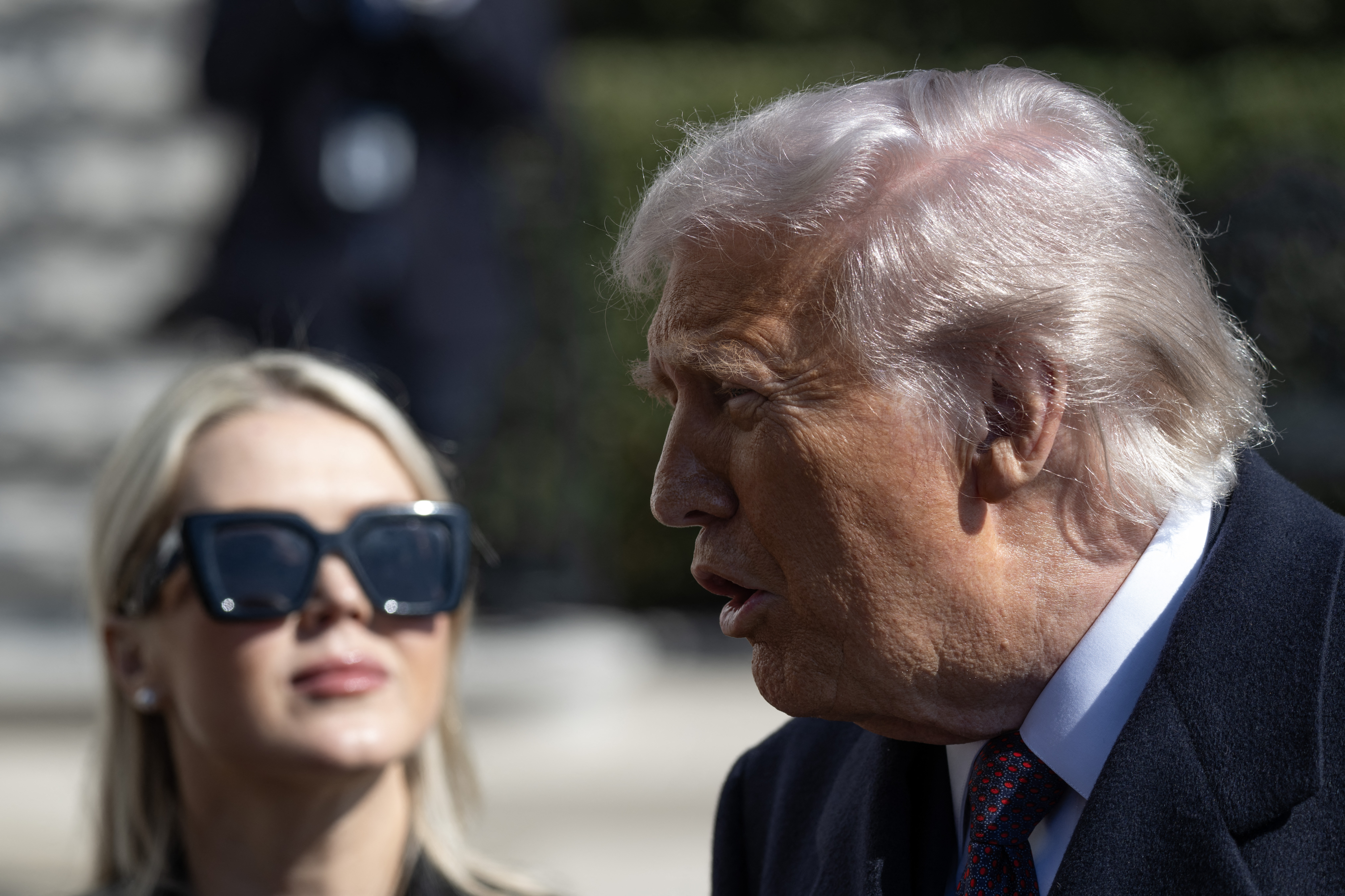Donald Trump speaks to reporters alongside Karoline Leavitt as he departs for Marine One on the South Lawn of the White House on March 11, 2026 in Washington, DC | Source: Getty Images