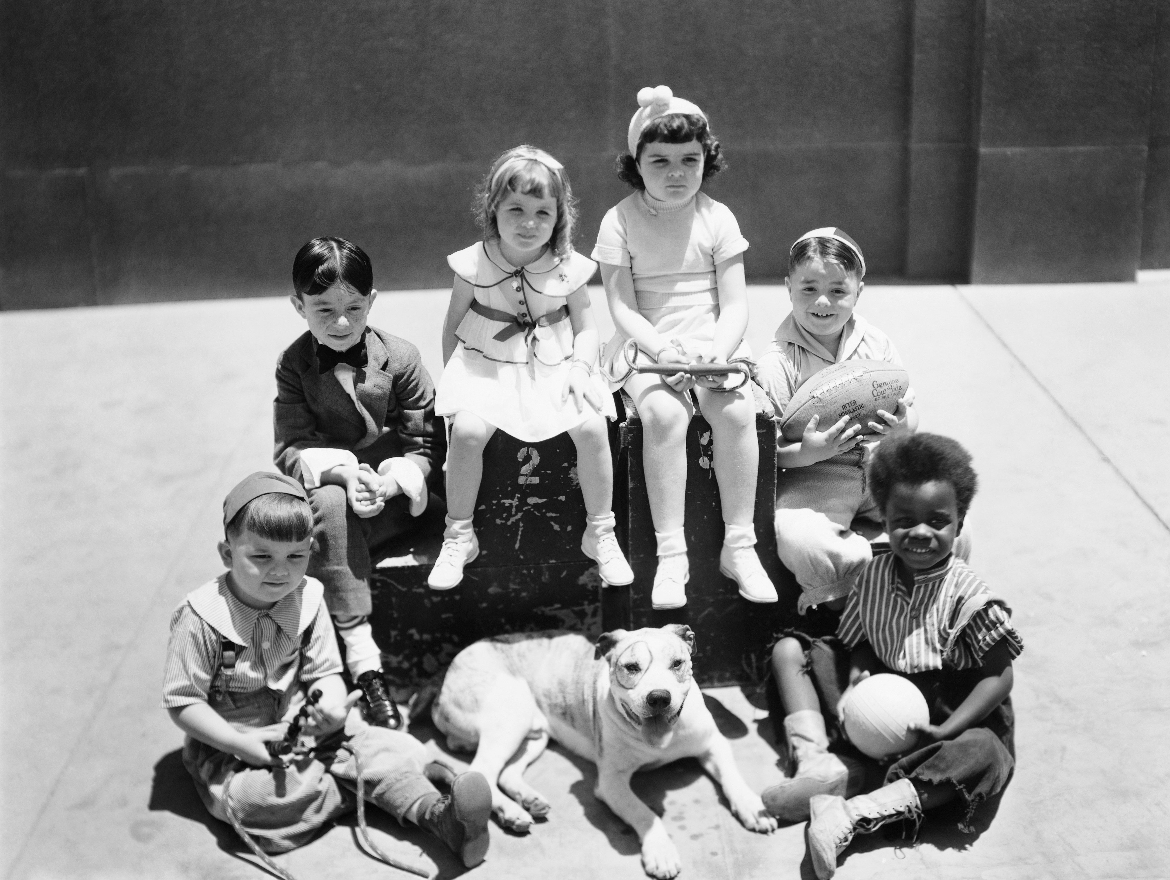 The cast of "Our Gang/Little Rascals" TV show, Hal Roach, MGM production. Spanky McFarland holding the football. | Source: Getty Images