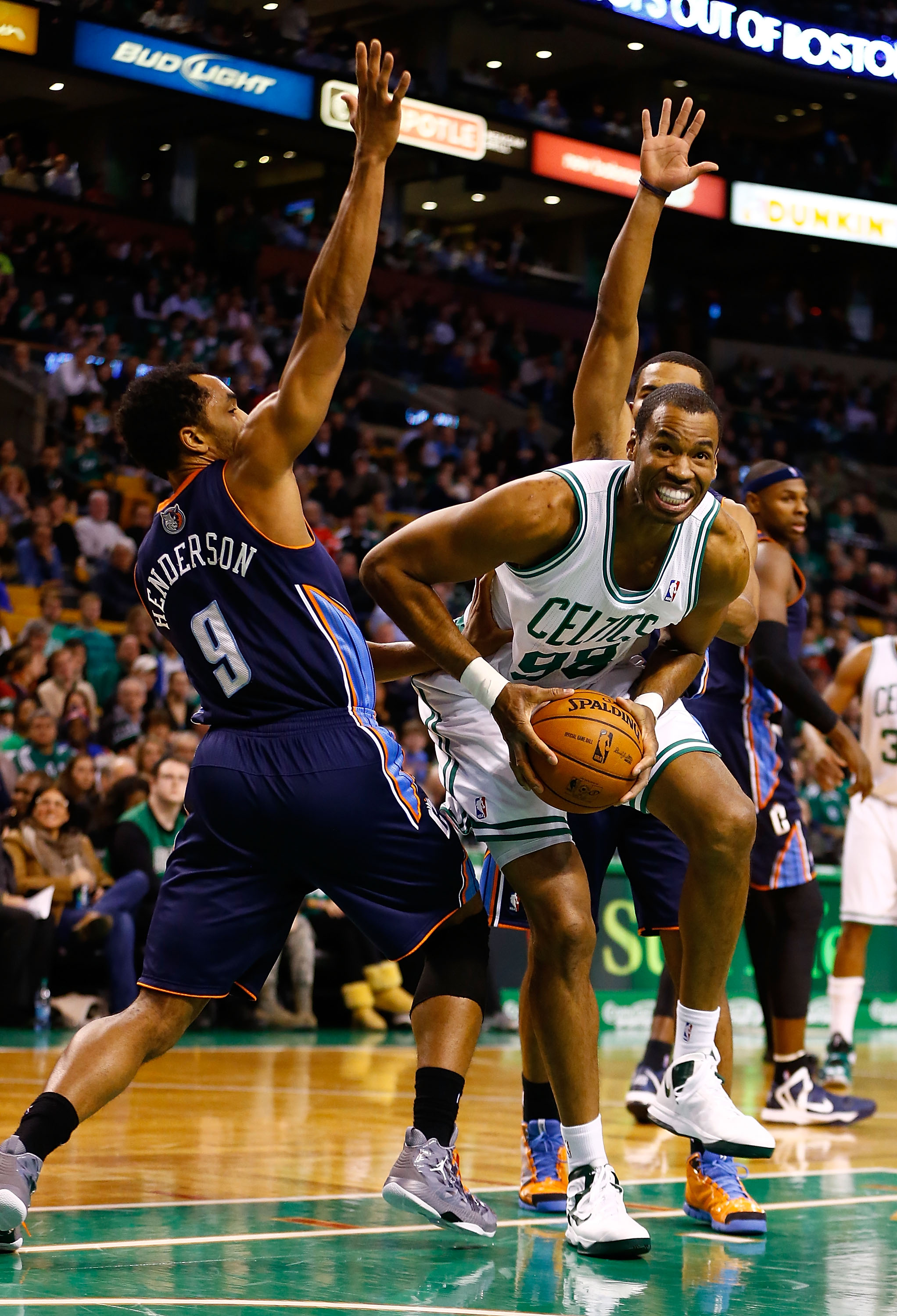 Jason Collins of the Boston Celtics drives between defenders in front of Gerald Henderson of the Charlotte Bobcats during a game at TD Garden in Boston on January 14, 2013. | Source: Getty Images