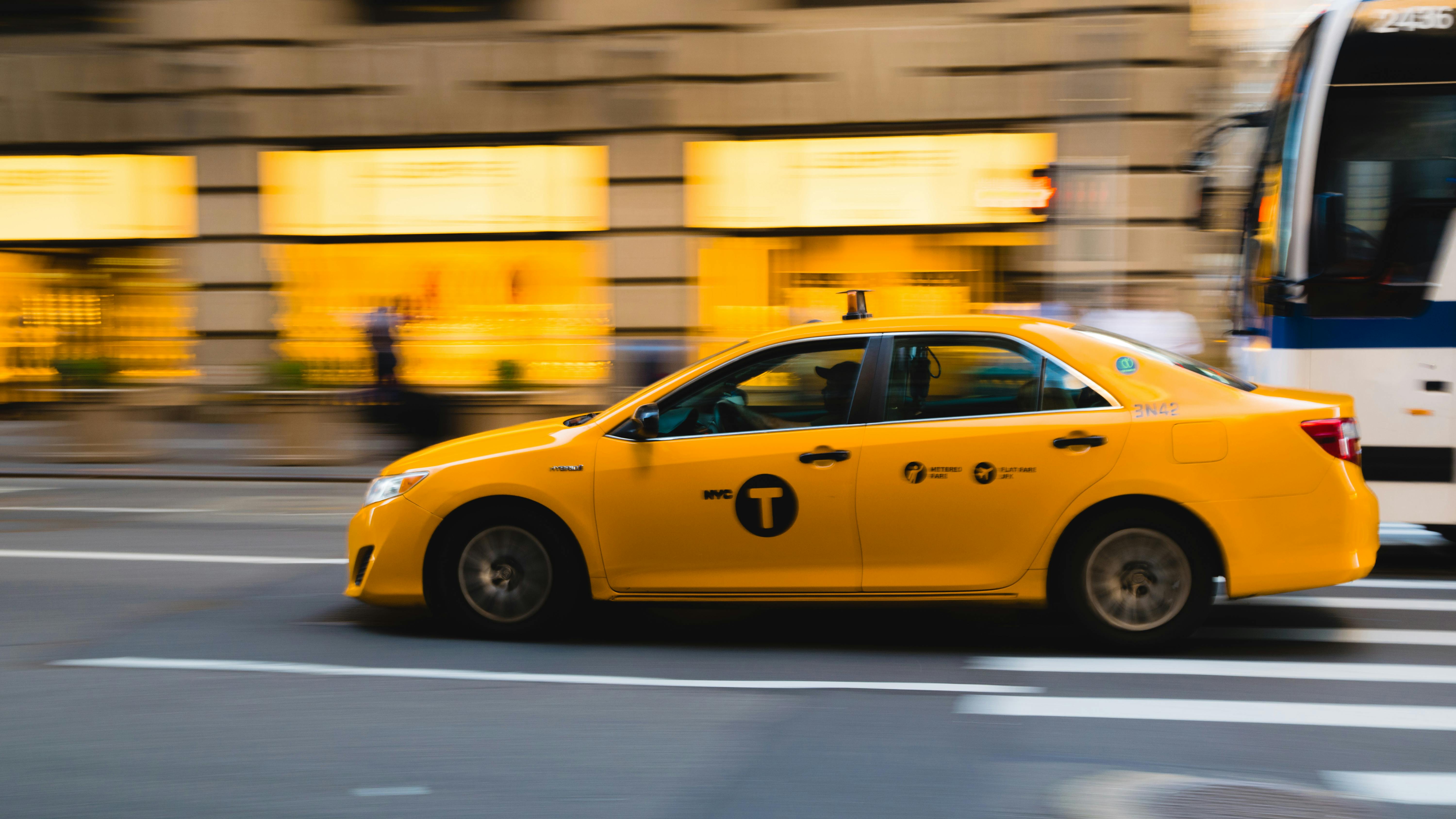 A yellow taxi driving | Source: Pexels