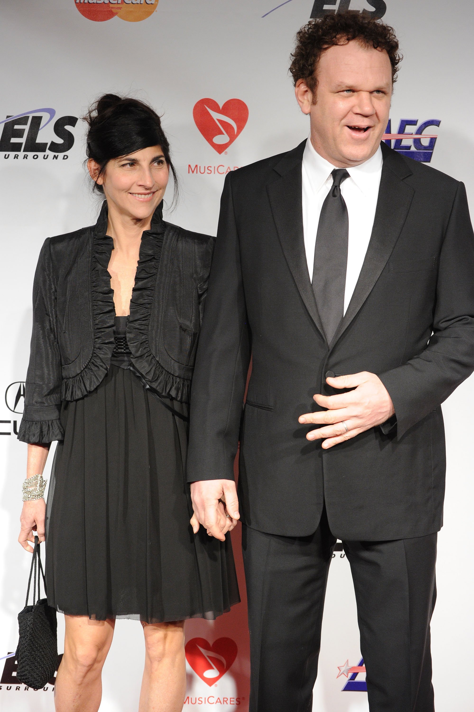 Actor John C. Reilly (R) and wife Alison Dickey arrive at 2010 MusiCares Person Of The Year Tribute To Neil Young at the Los Angeles Convention Center on January 29, 2010 in Los Angeles, California. | Source: Getty Images