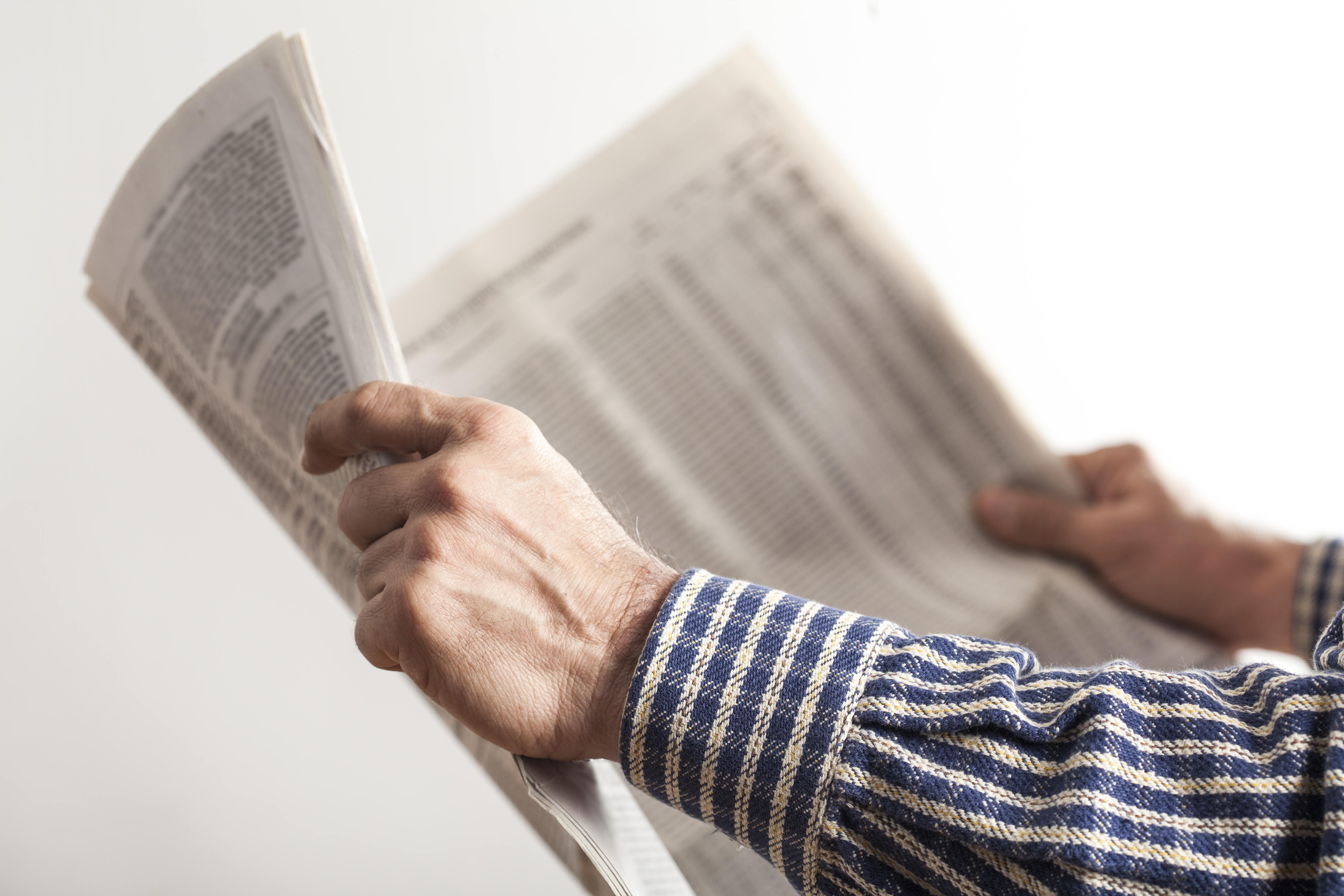 Man reading newspaper | Source: Shutterstock