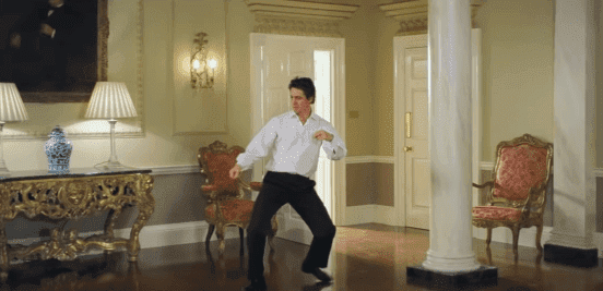 Hugh Grant dancing through 10 Downing Street in the film "Love Actually." | Source: YouTube/Movieclips.