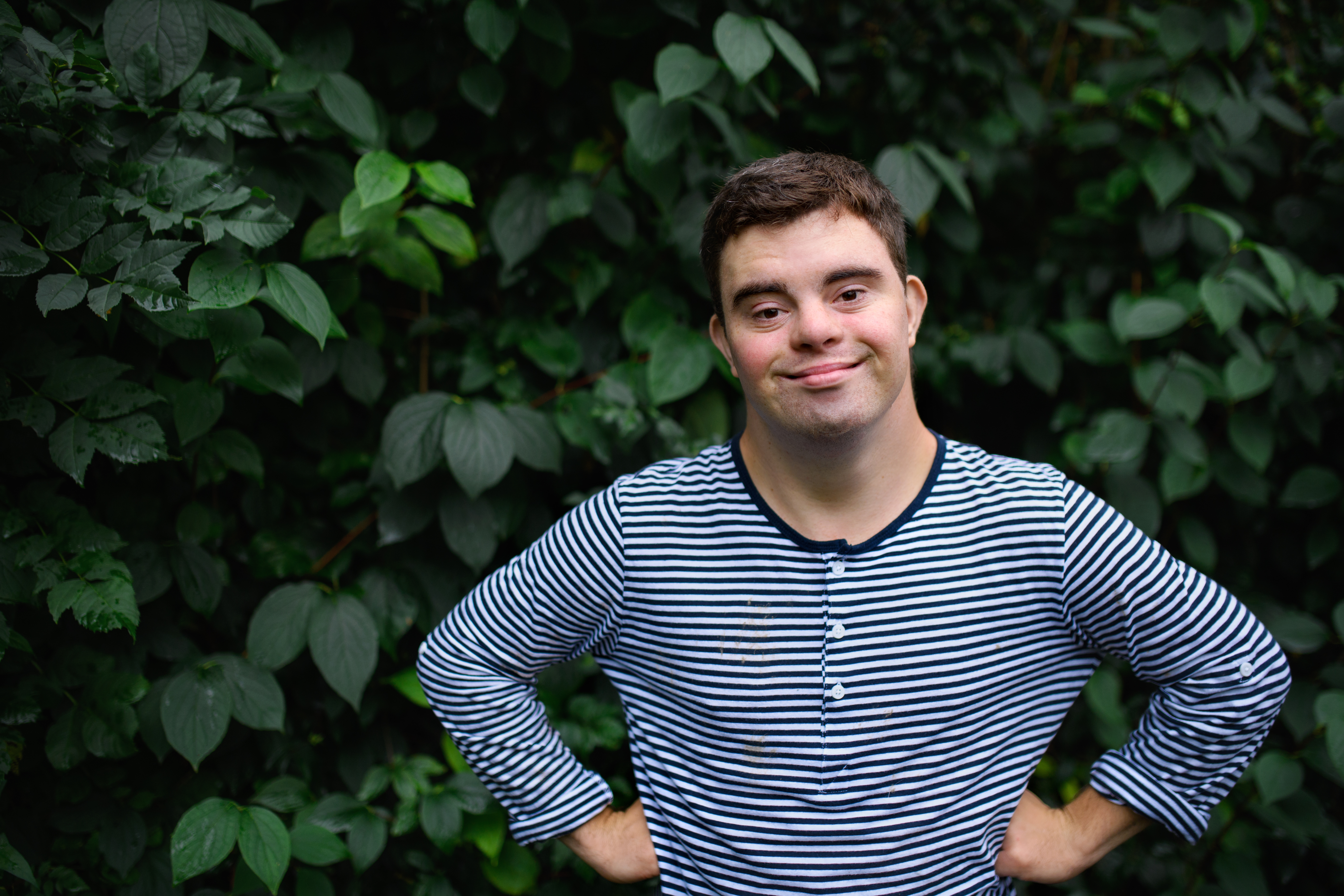 Man with Down syndrome posing outside. | Source: Shutterstock