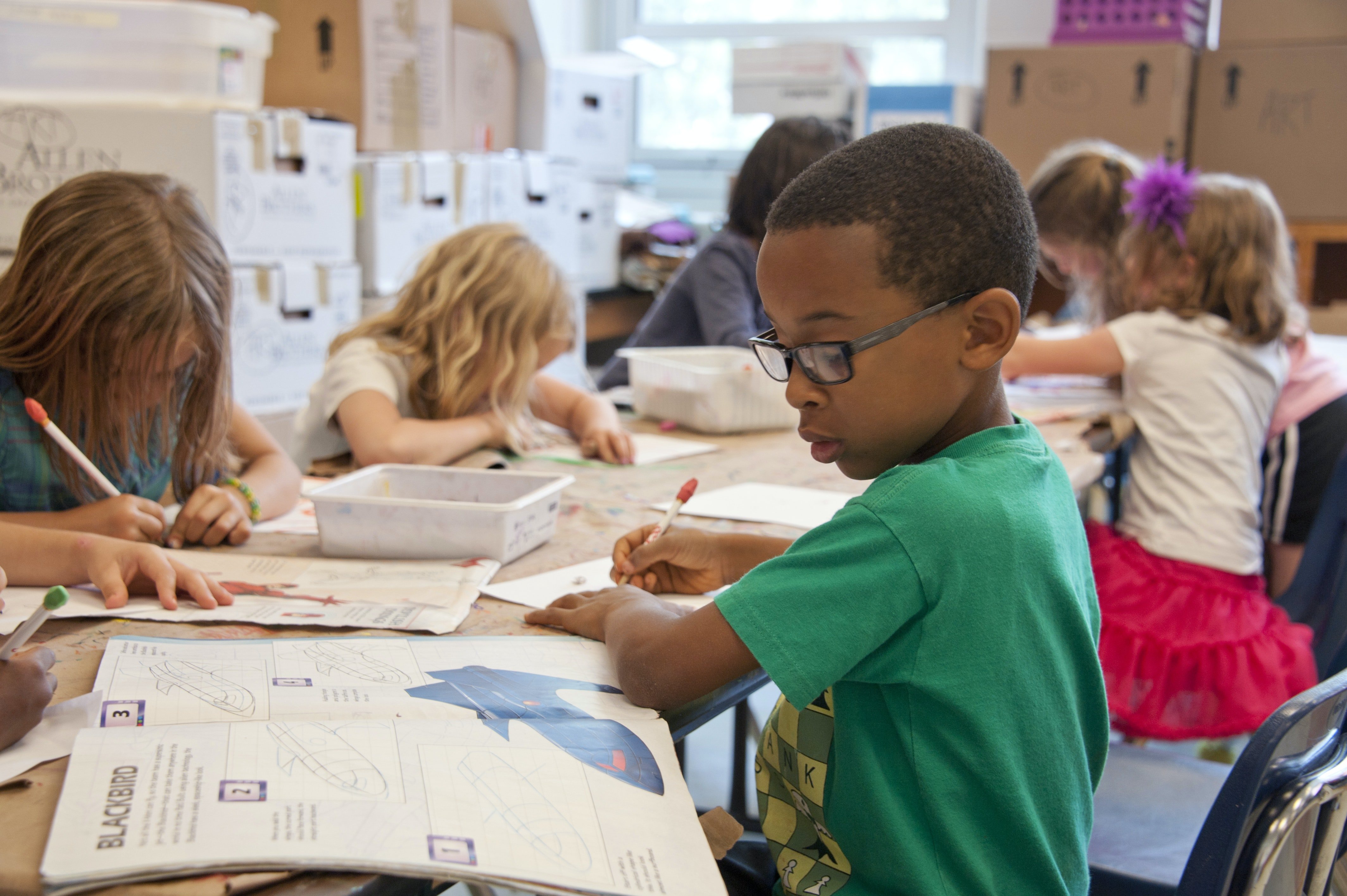 School children sitting in a classroom doing school work. | Source: Pexels/ CDC