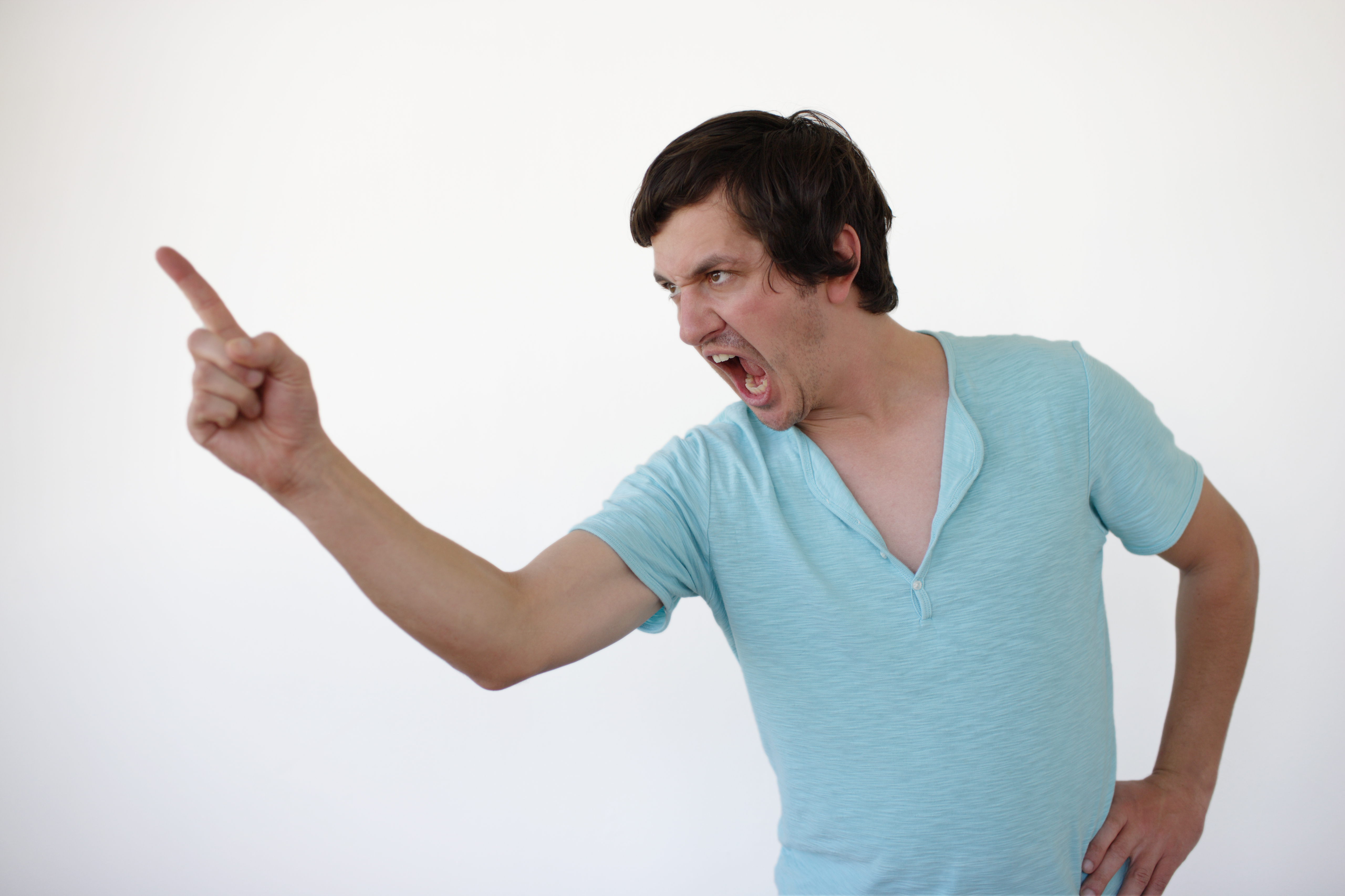 Young man pointing his finger, shouting | Source: Getty Images