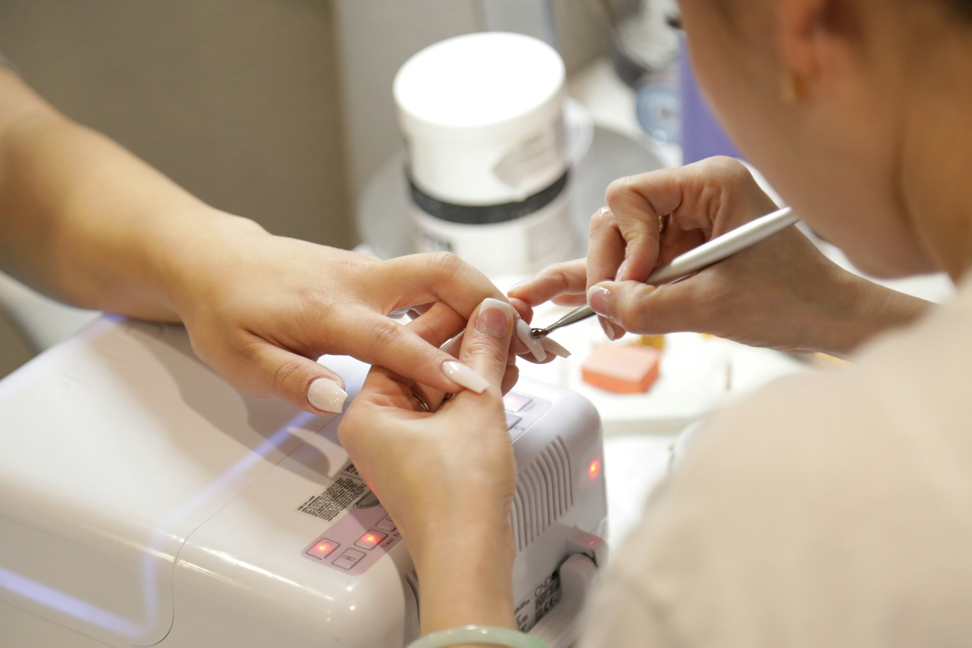A client getting her nails done at a nail salon | Source: Unsplash
