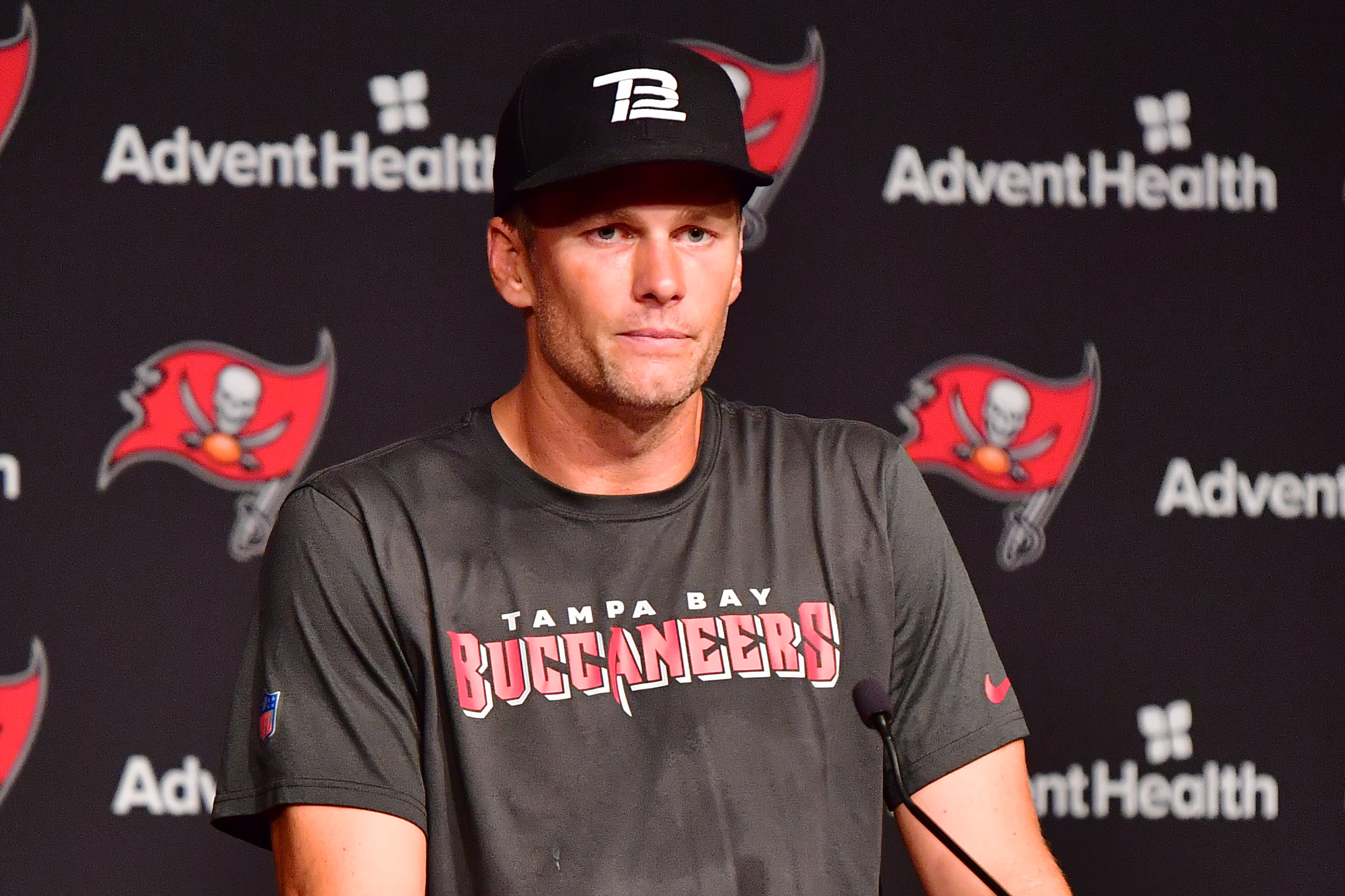 Tom Brady #12 of Tampa Bay Buccaneers answers questions at a press conference following the 2022 Buccaneers minicamp at AdventHealth Training Center on June 9 in Tampa, Florida. | Source: Getty Images