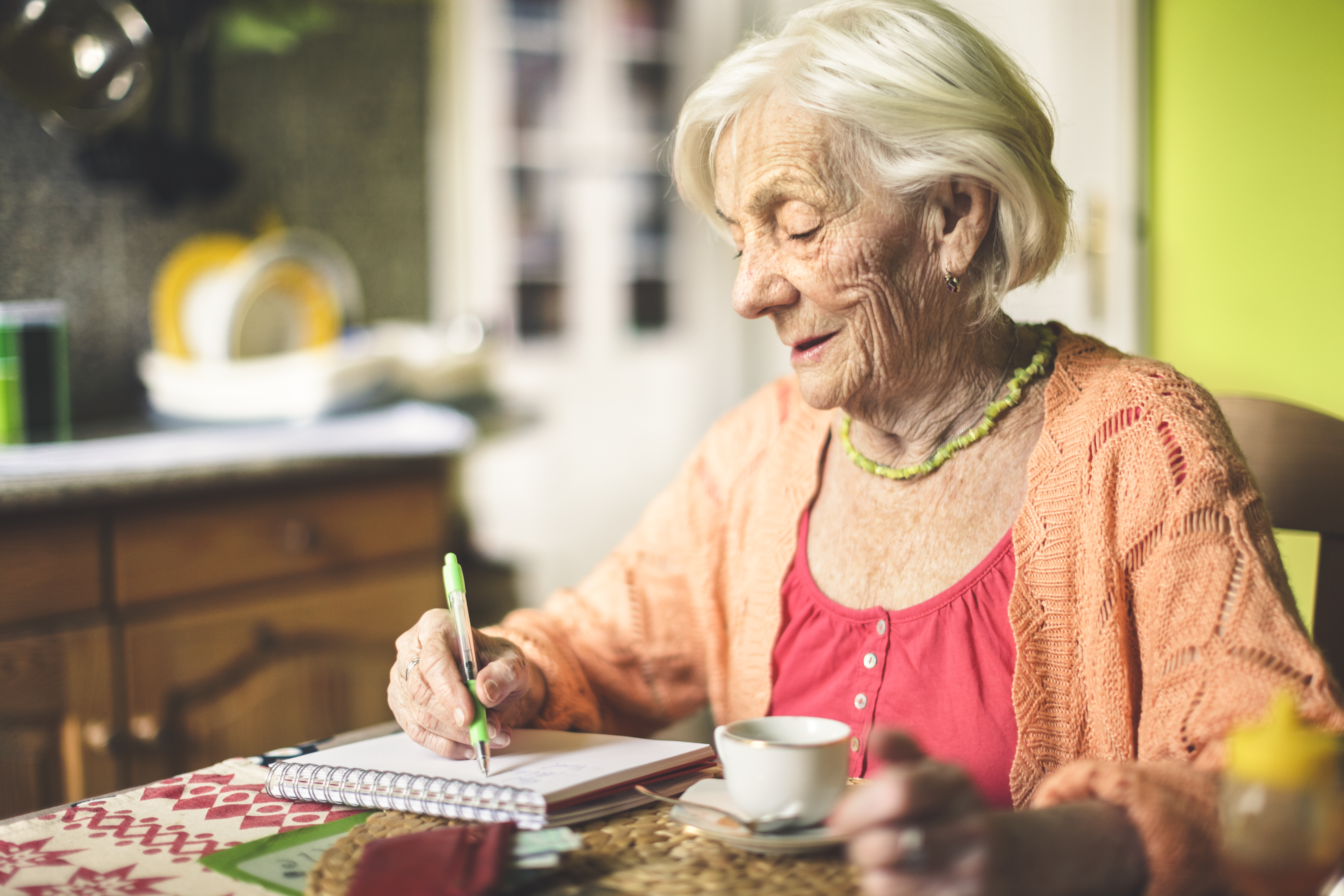Senior woman calculating finances in her kitchen | Source: Getty Images