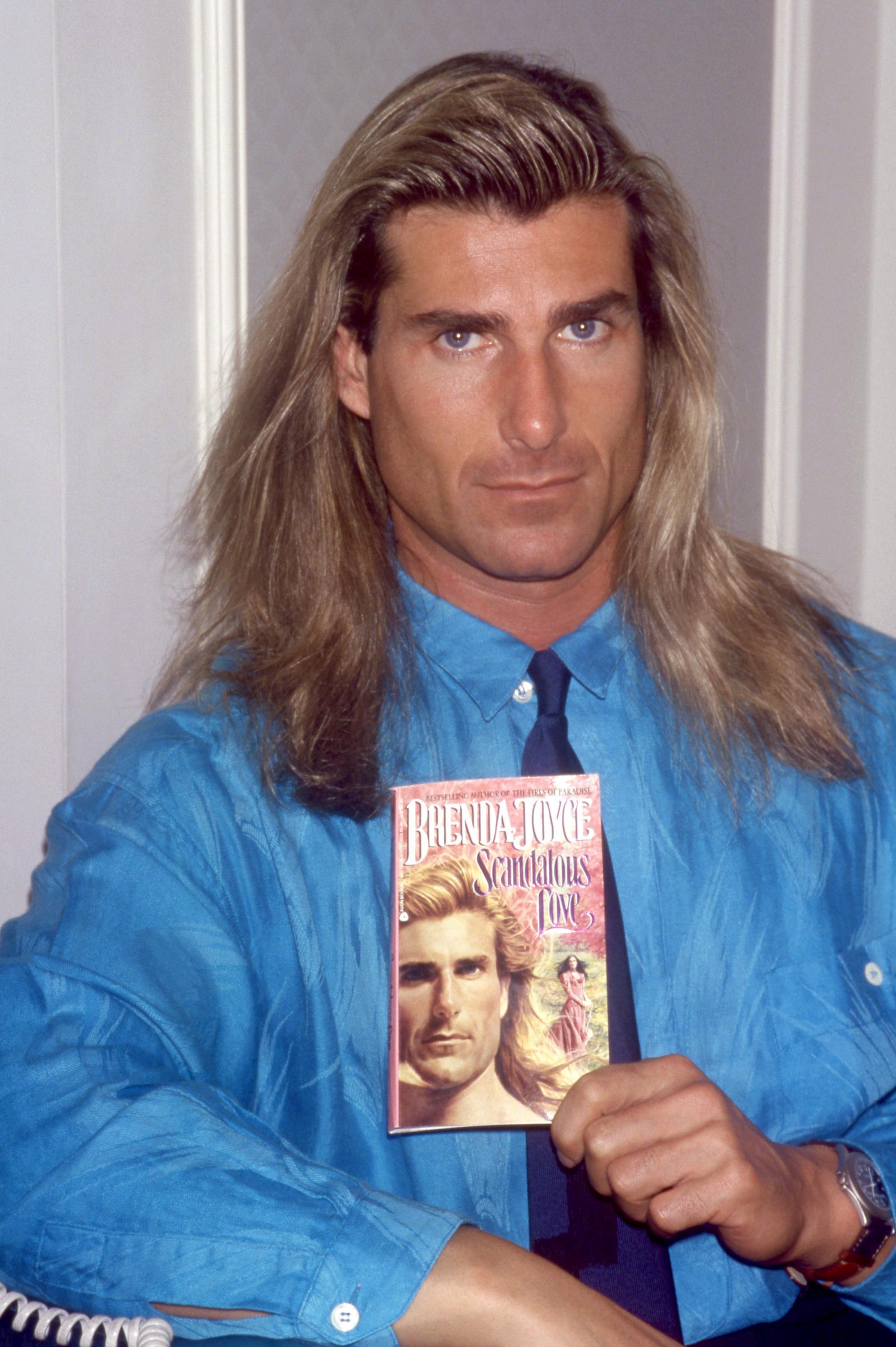 Despite how famous he became, he held strong opinions about how people were losing their lives to social media. In this photo, Fabio Lanzoni posed for a portrait with Brenda Joyce's book "Scandalous Love" on November 8, 1992, in New York City, New York. | Source: Getty Images