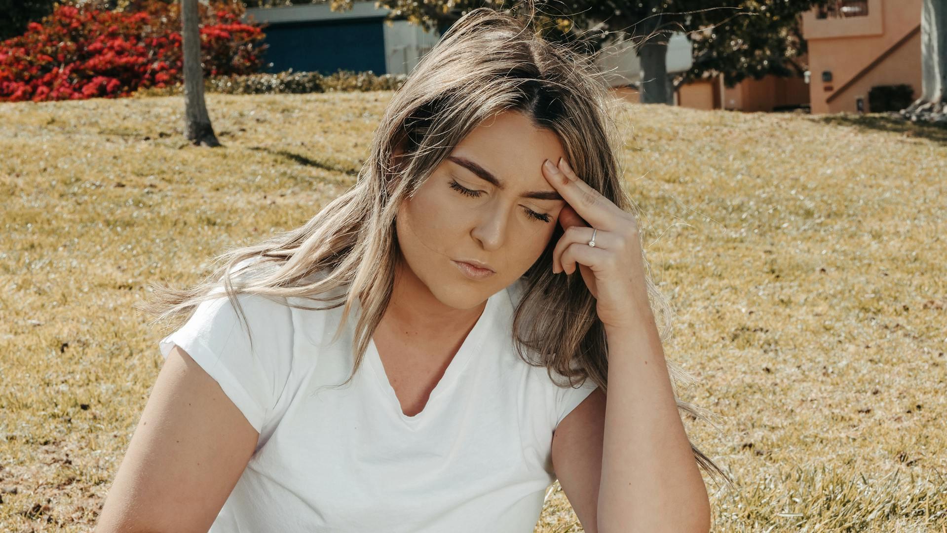 A stressed woman holding her head | Source: Pexels